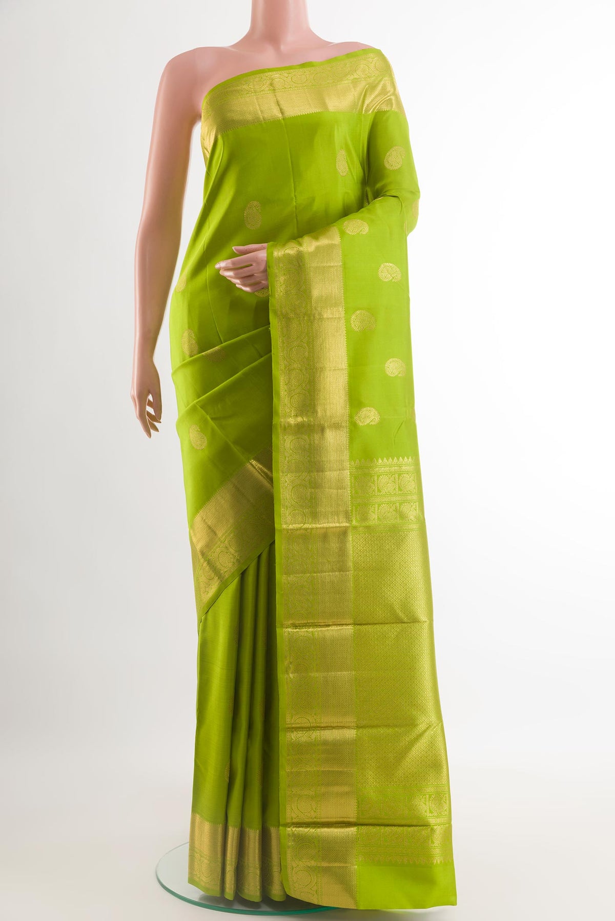Green Kanjivaram Silk Saree with Zari Butta on the body and Zari Border.  displayed on a mannequin