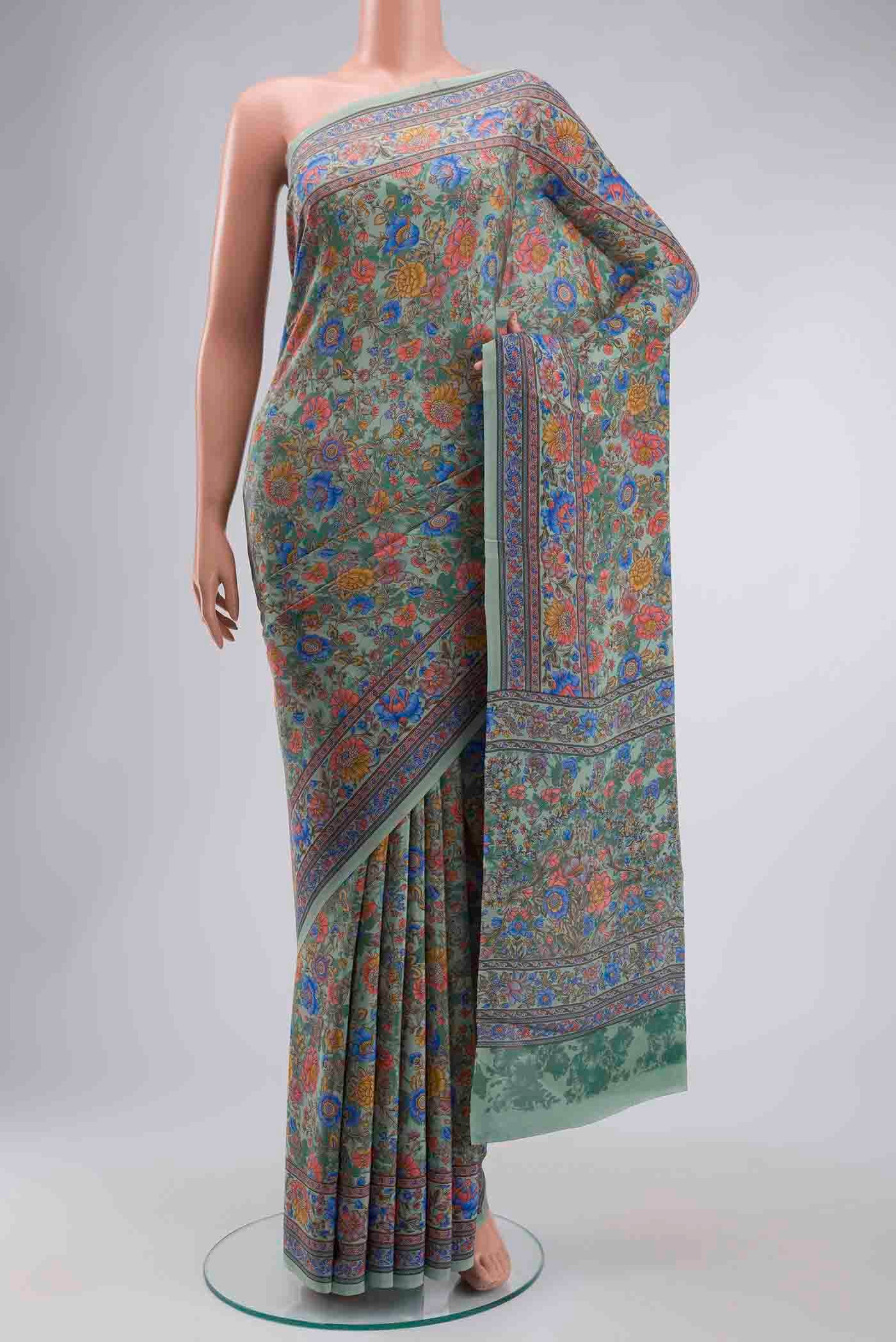 Sage Green Crepe Saree with Printed design on the body and Printed Border displayed on a mannequin