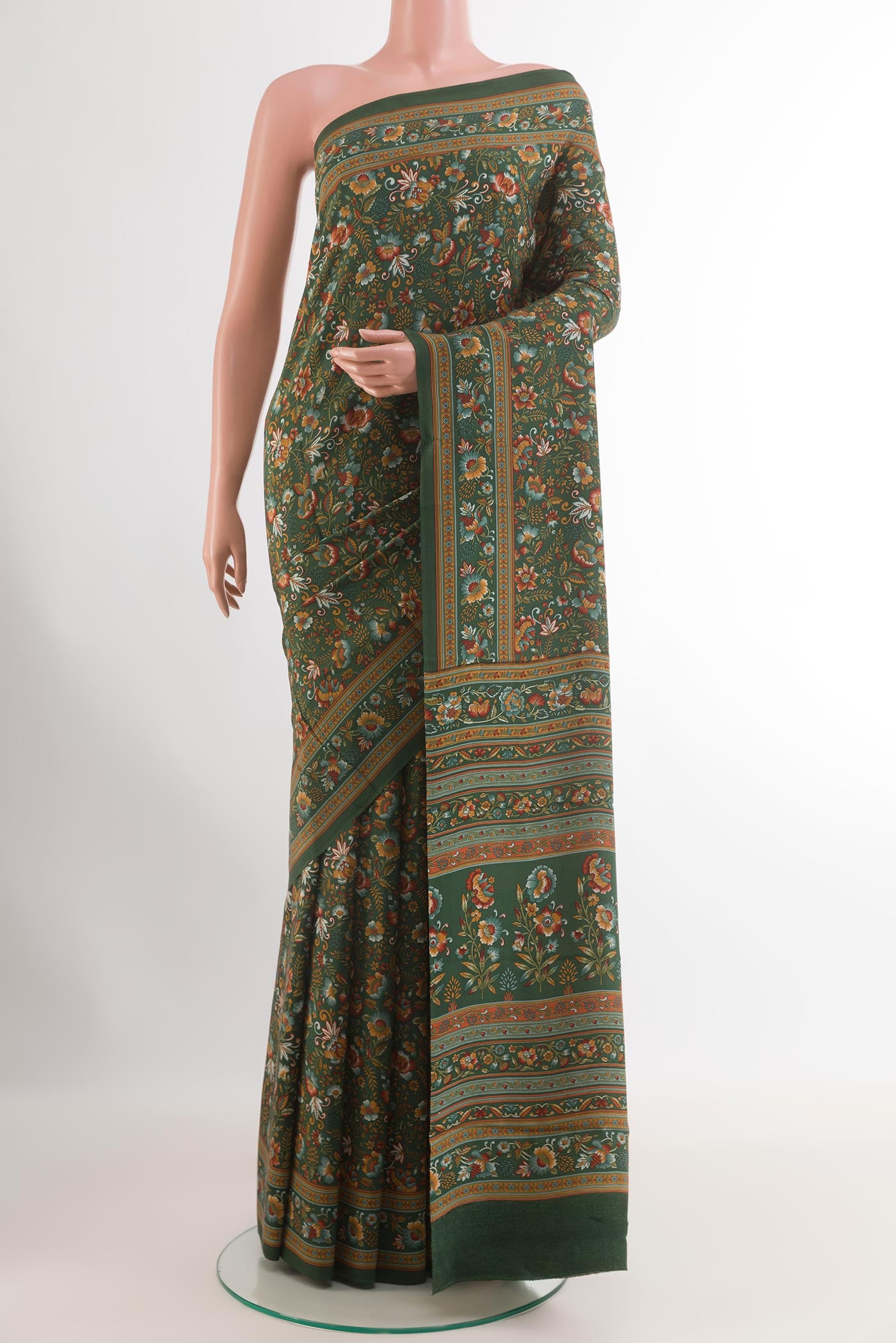 Green Crepe Saree with Printed design on the body and Printed Border.  displayed on a mannequin