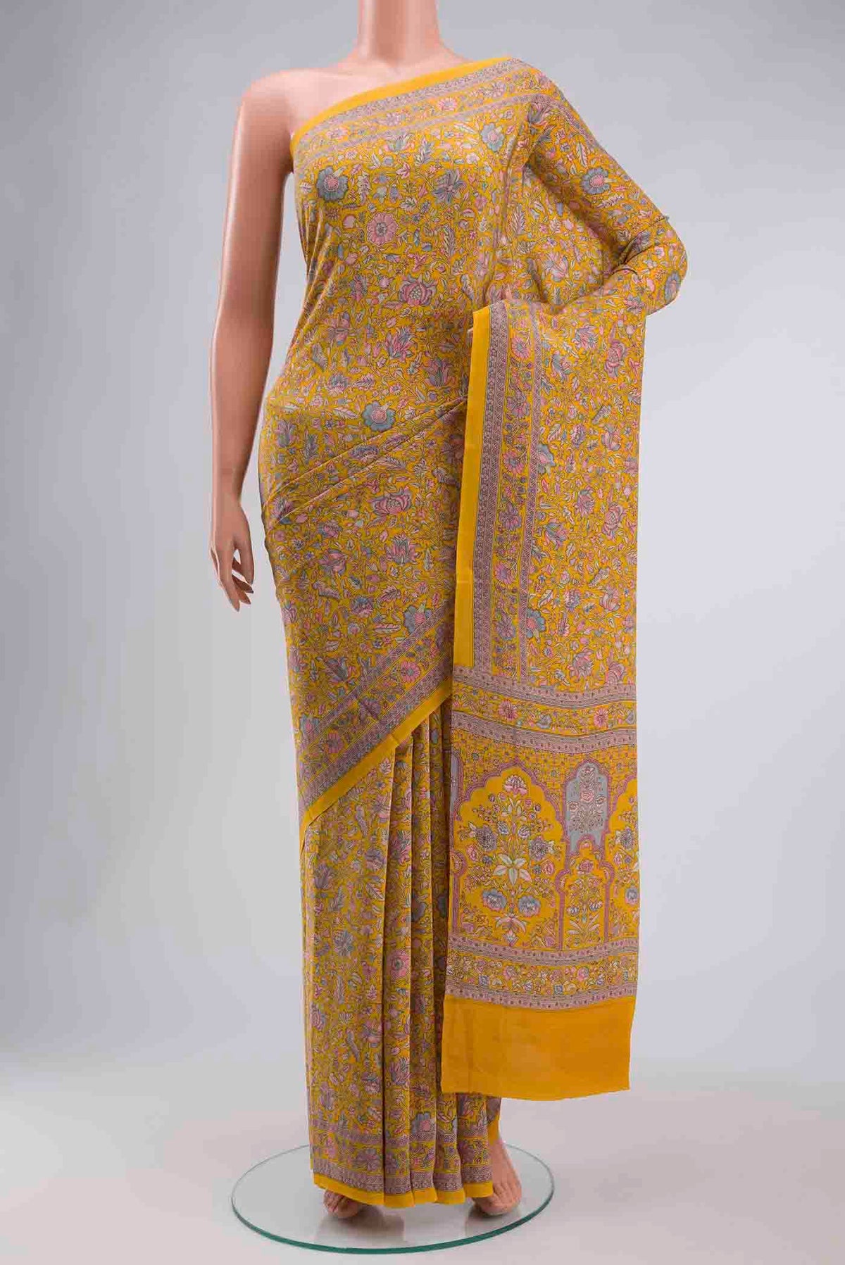 Yellow Mysore Crepe Saree with Printed design on the body and Printed Border displayed on a mannequin