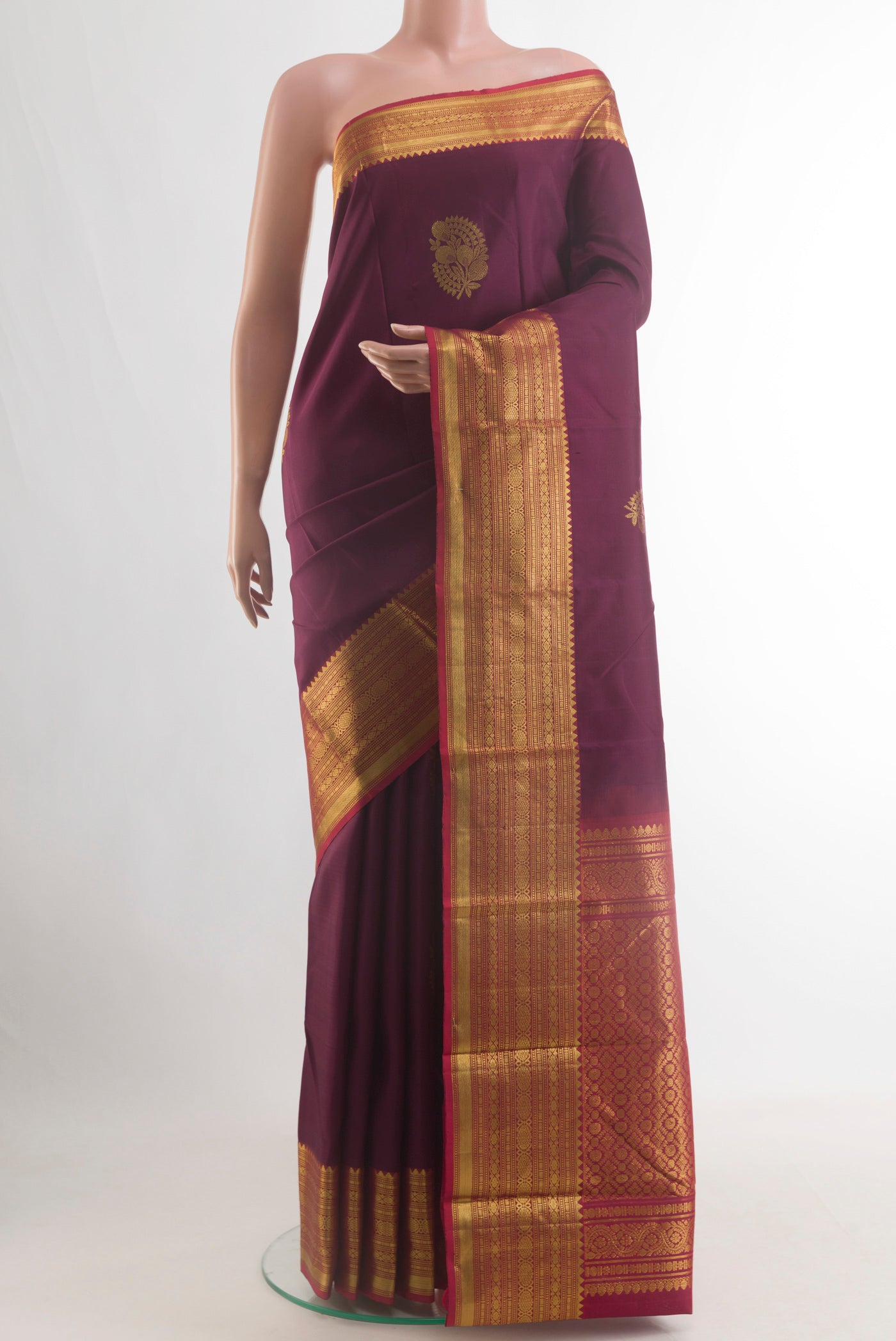 Pure Silk Purple Kanchipuram Saree with Zari Butta on the body and Zari Border.  displayed on a mannequin