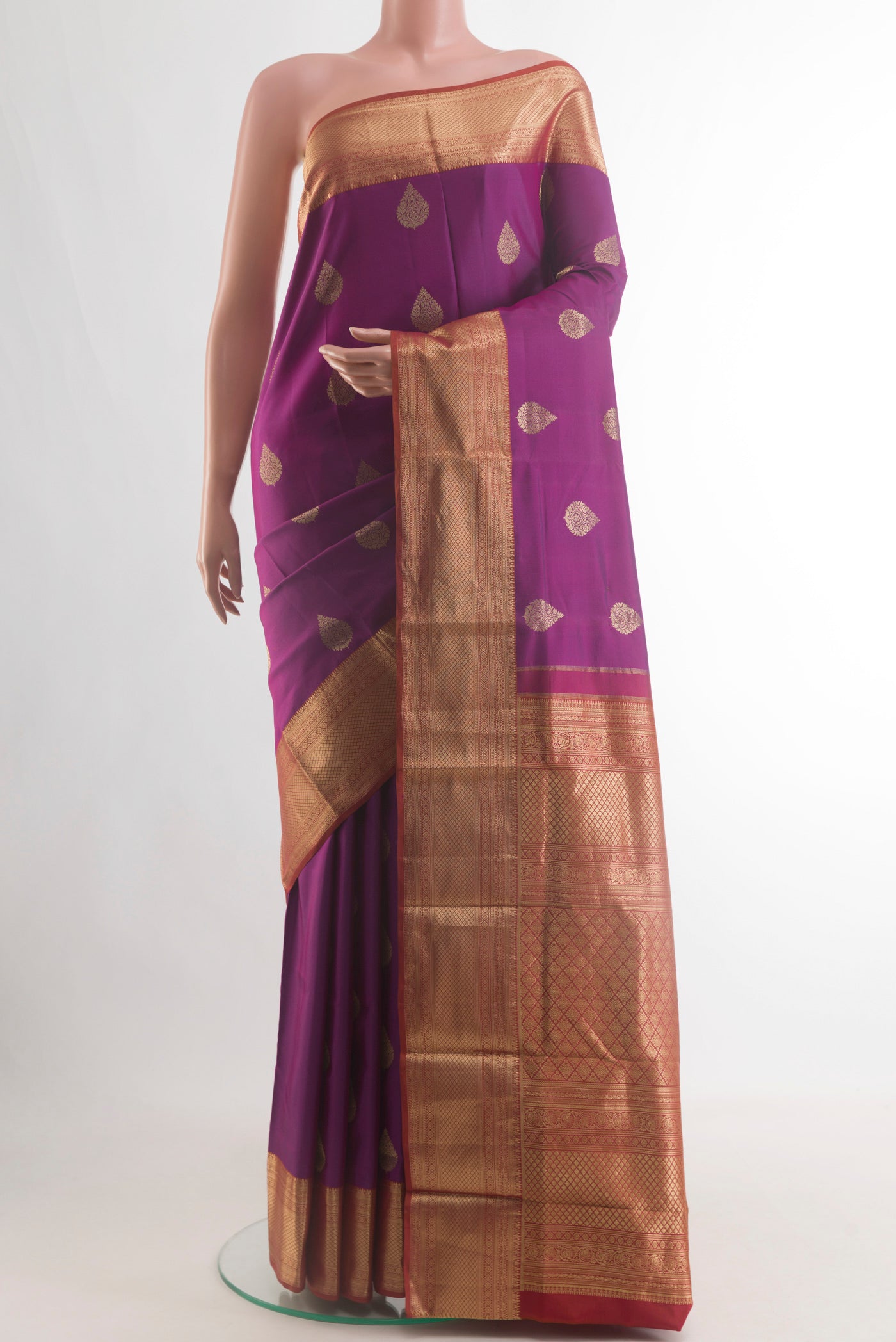 Pure Silk Purple Kanjivaram Saree with Zari Butta on the body and Zari Border.  displayed on a mannequin