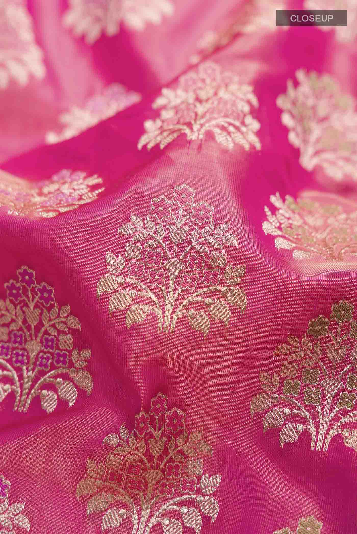 Close up of Pink Banarasi Silk Saree with Zari Butta on the body and Zari Border displaying folds