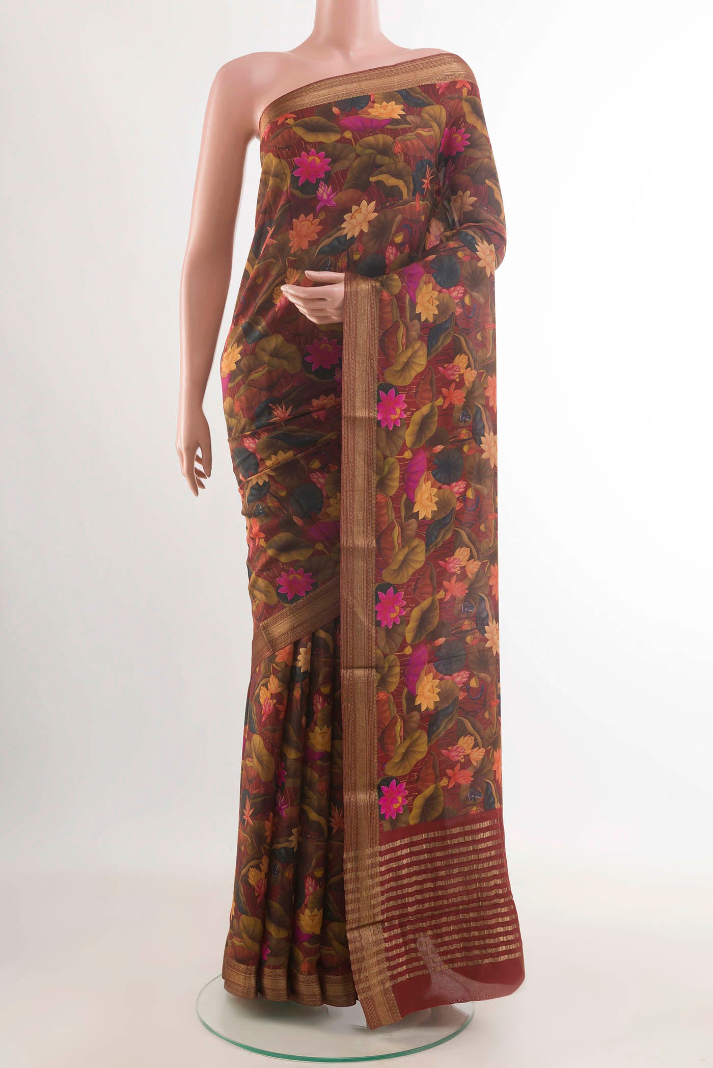 Maroon Printed Silk Saree with Printed design on the body and Zari Border displayed on a mannequin