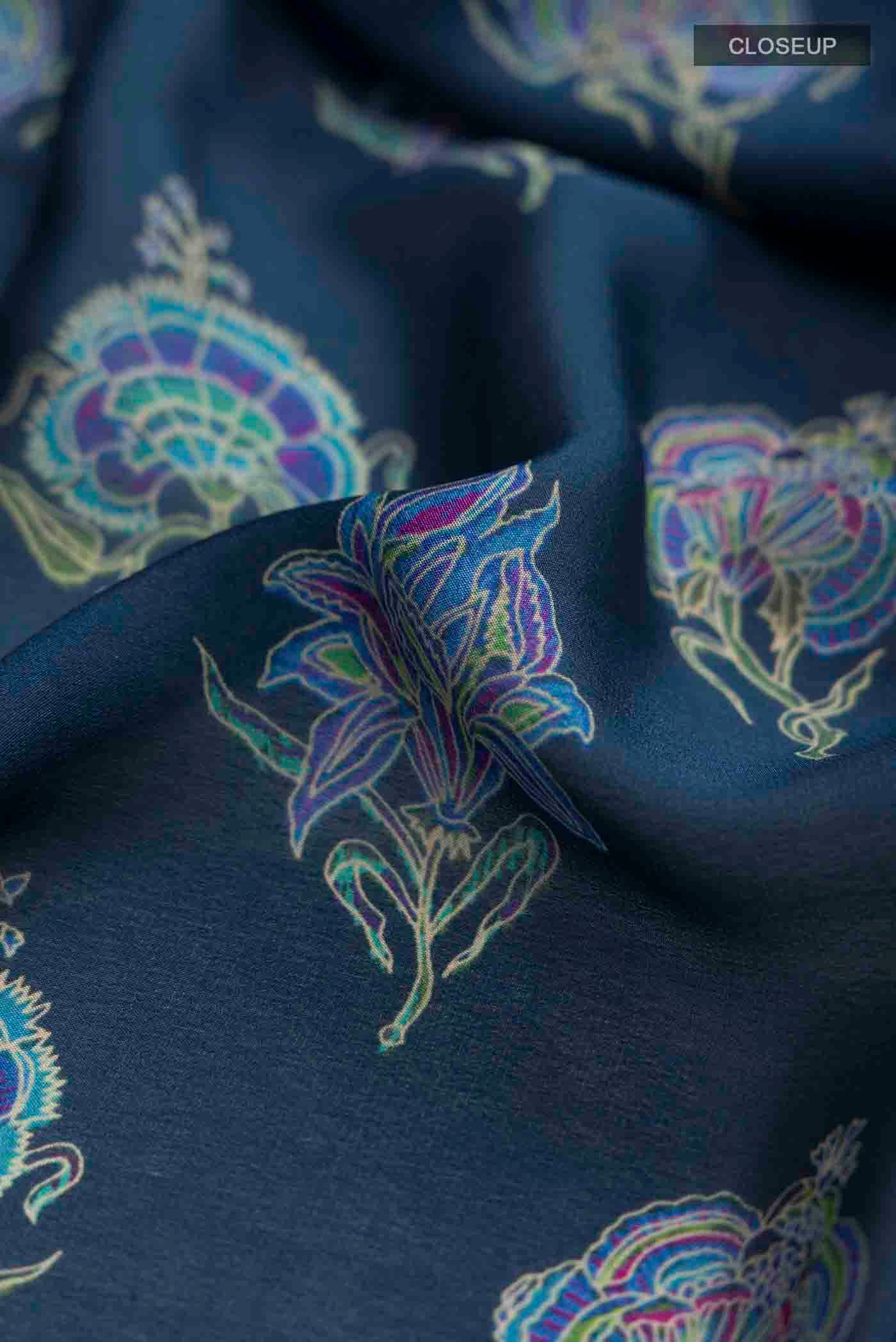 Close up of Blue Crepe Saree with Printed design on the body and Zari Border displaying folds
