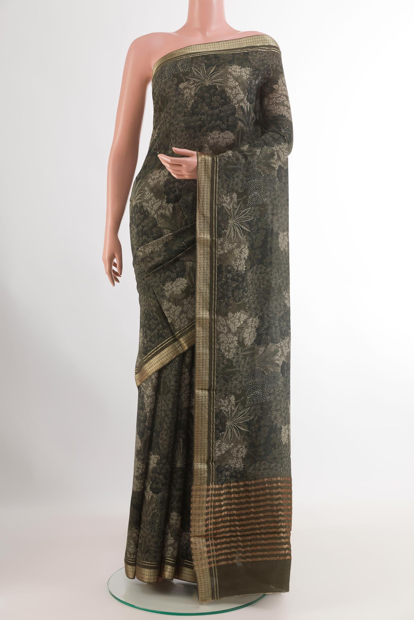 Green Crepe Saree with Printed design on the body and Zari Border.  displayed on a mannequin