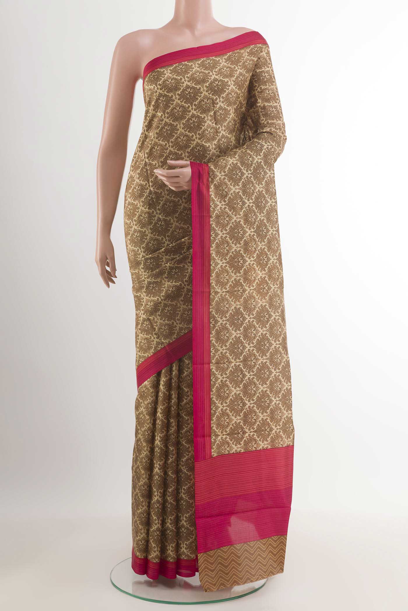 Beige Printed Silk Saree with Printed design on the body and Plain Border.  displayed on a mannequin