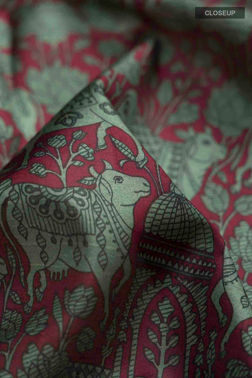 Close up of Maroon Printed Silk Saree with Printed design on the body and Plain Border displaying folds