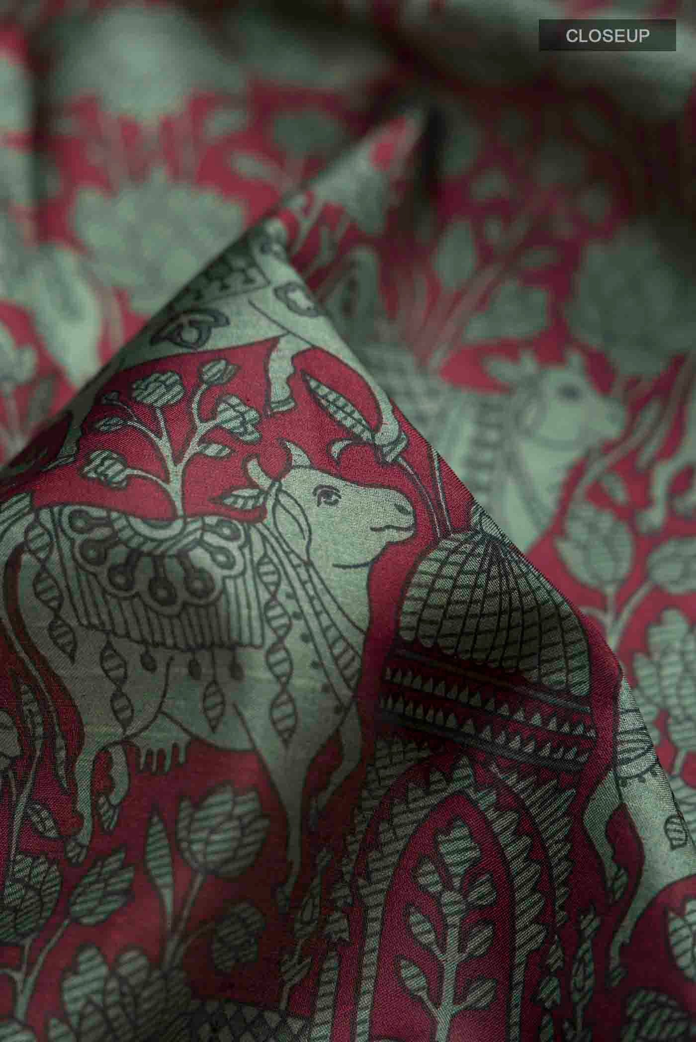 Close up of Maroon Printed Silk Saree with Printed design on the body and Plain Border displaying folds