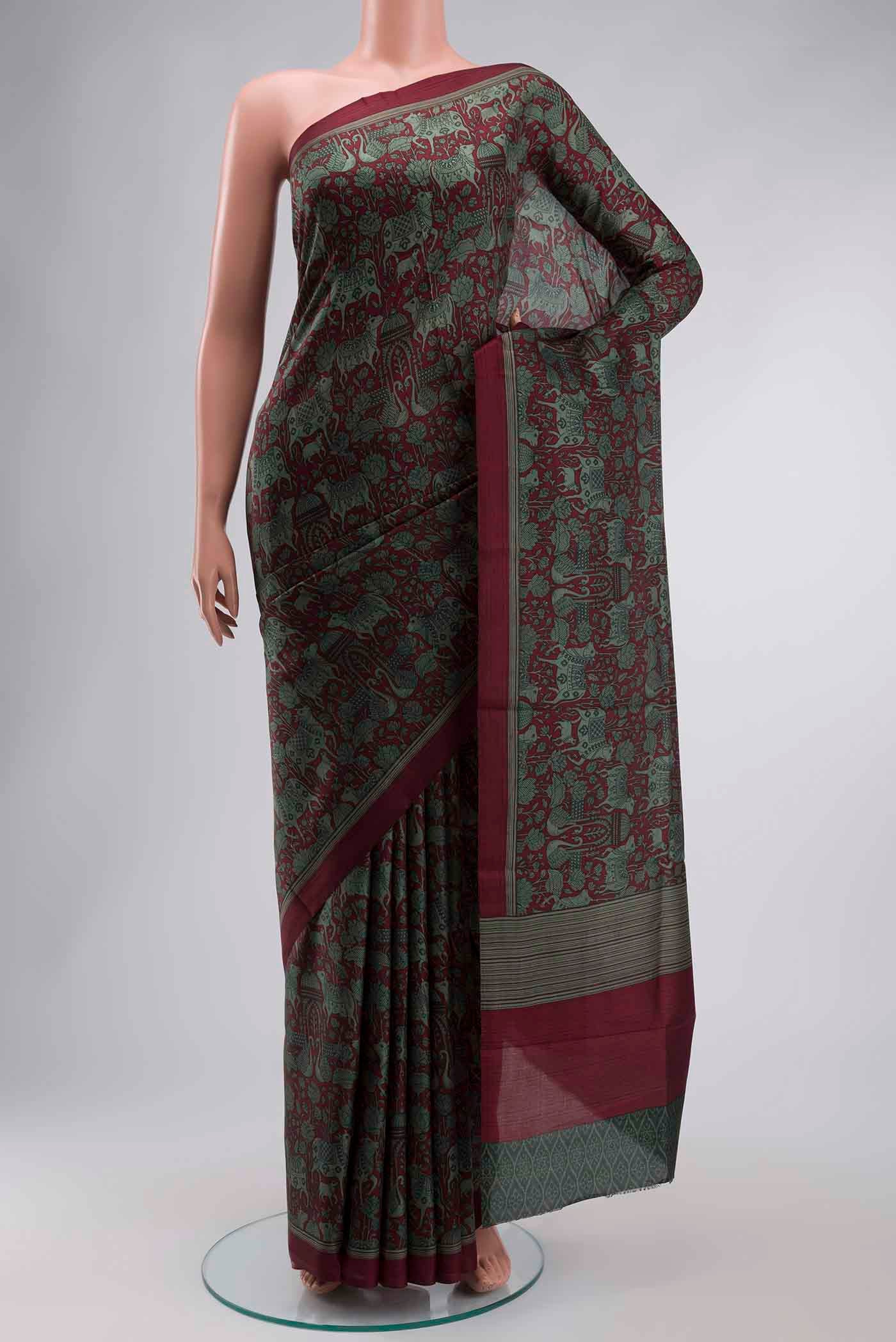 Maroon Printed Silk Saree with Printed design on the body and Plain Border displayed on a mannequin