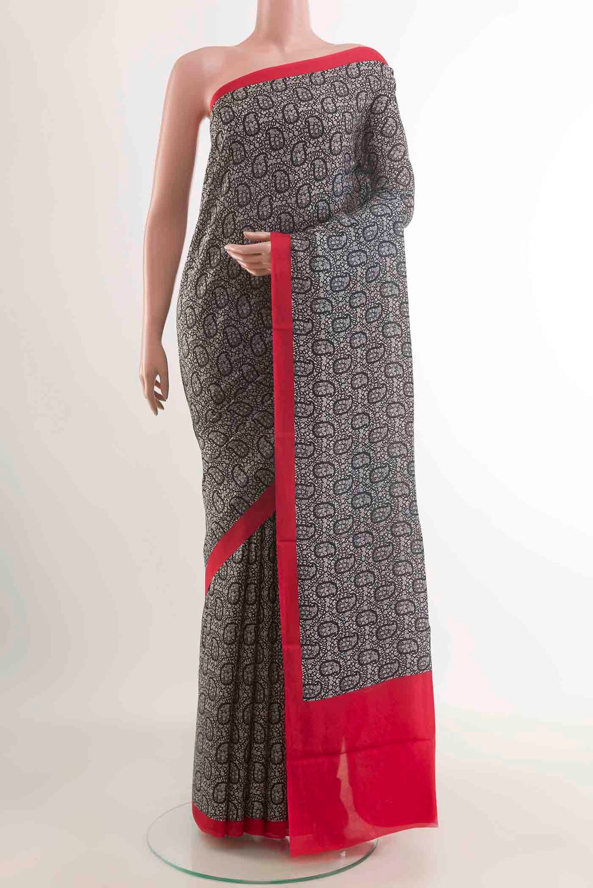 Black Printed Silk Saree with Printed design on the body and Plain Border displayed on a mannequin
