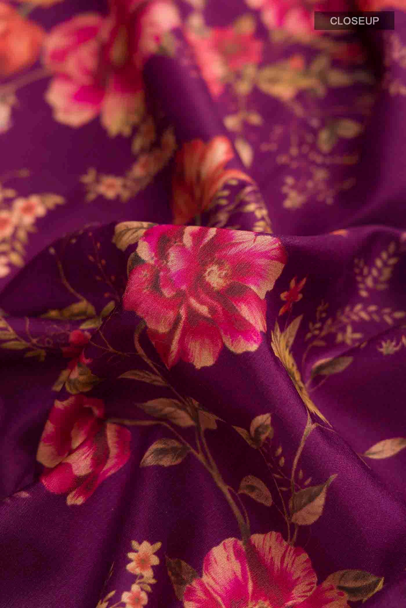 Close up of Magenta Printed Silk Saree with Printed design on the body and Zari Border displaying folds