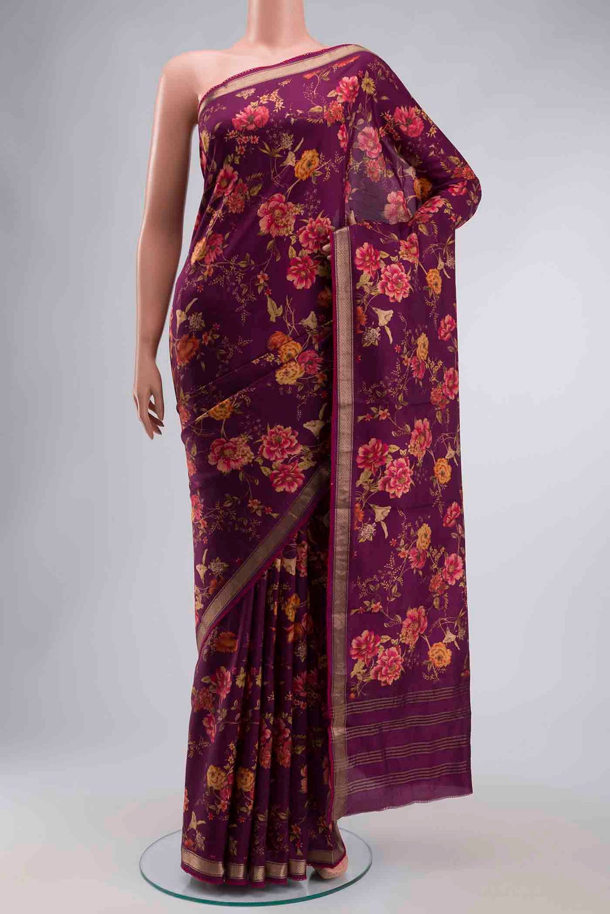 Magenta Printed Silk Saree with Printed design on the body and Zari Border displayed on a mannequin