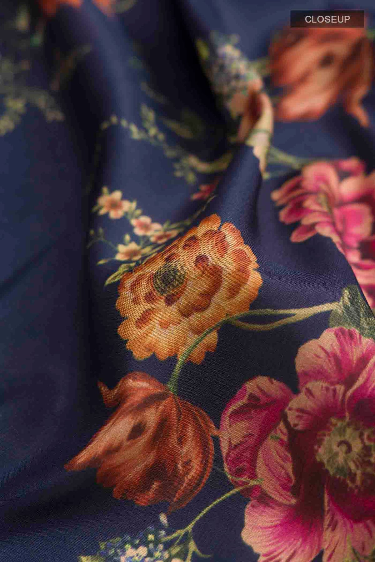 Close up of Navy Blue Printed Silk Saree with Printed design on the body and Zari Border displaying folds