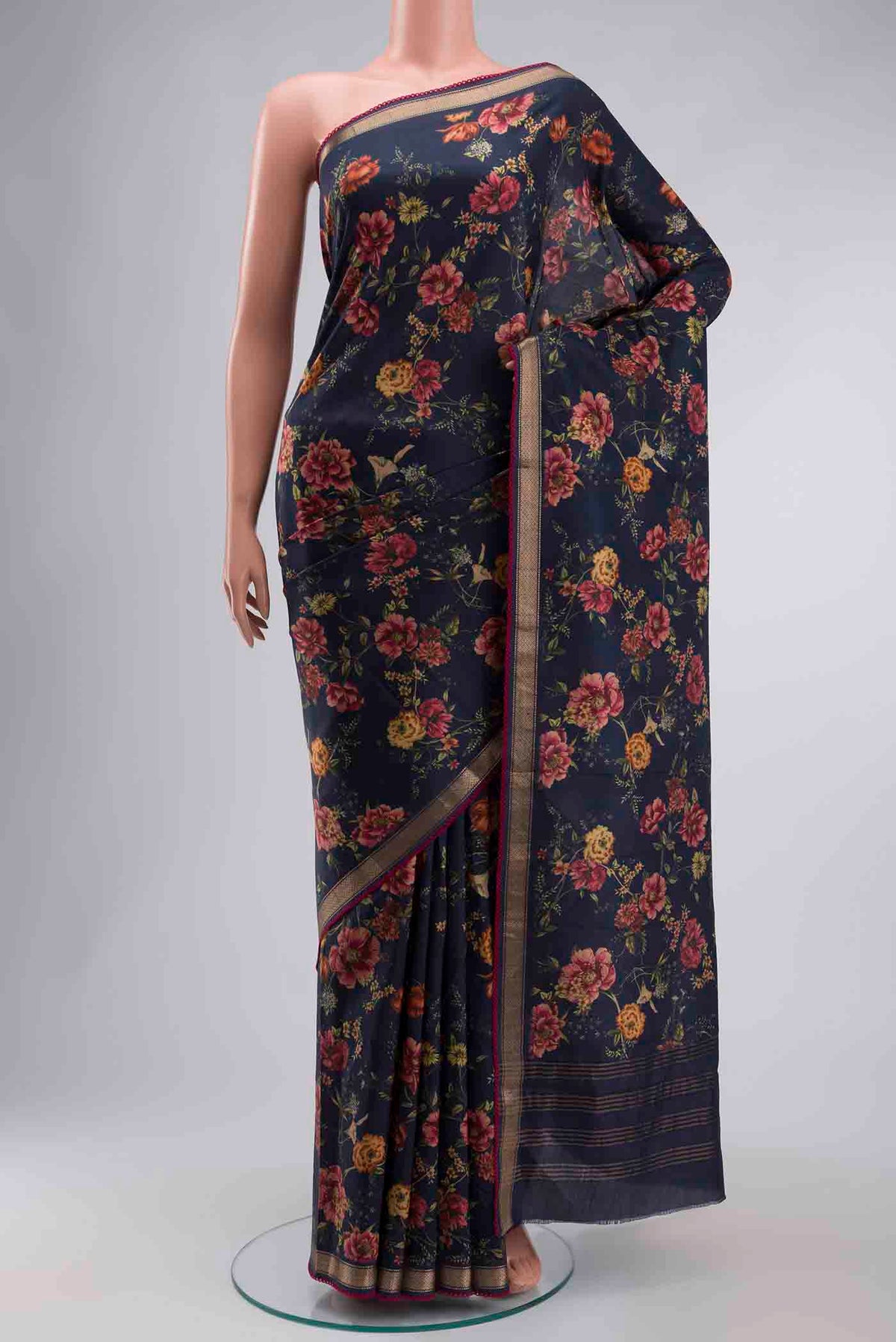 Navy Blue Printed Silk Saree with Printed design on the body and Zari Border displayed on a mannequin