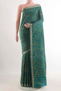 Green Printed Silk Saree with Printed design on the body and Zari Border displayed on a mannequin