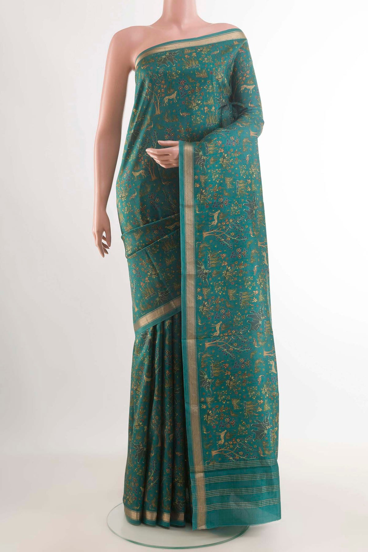 Green Printed Silk Saree with Printed design on the body and Zari Border displayed on a mannequin