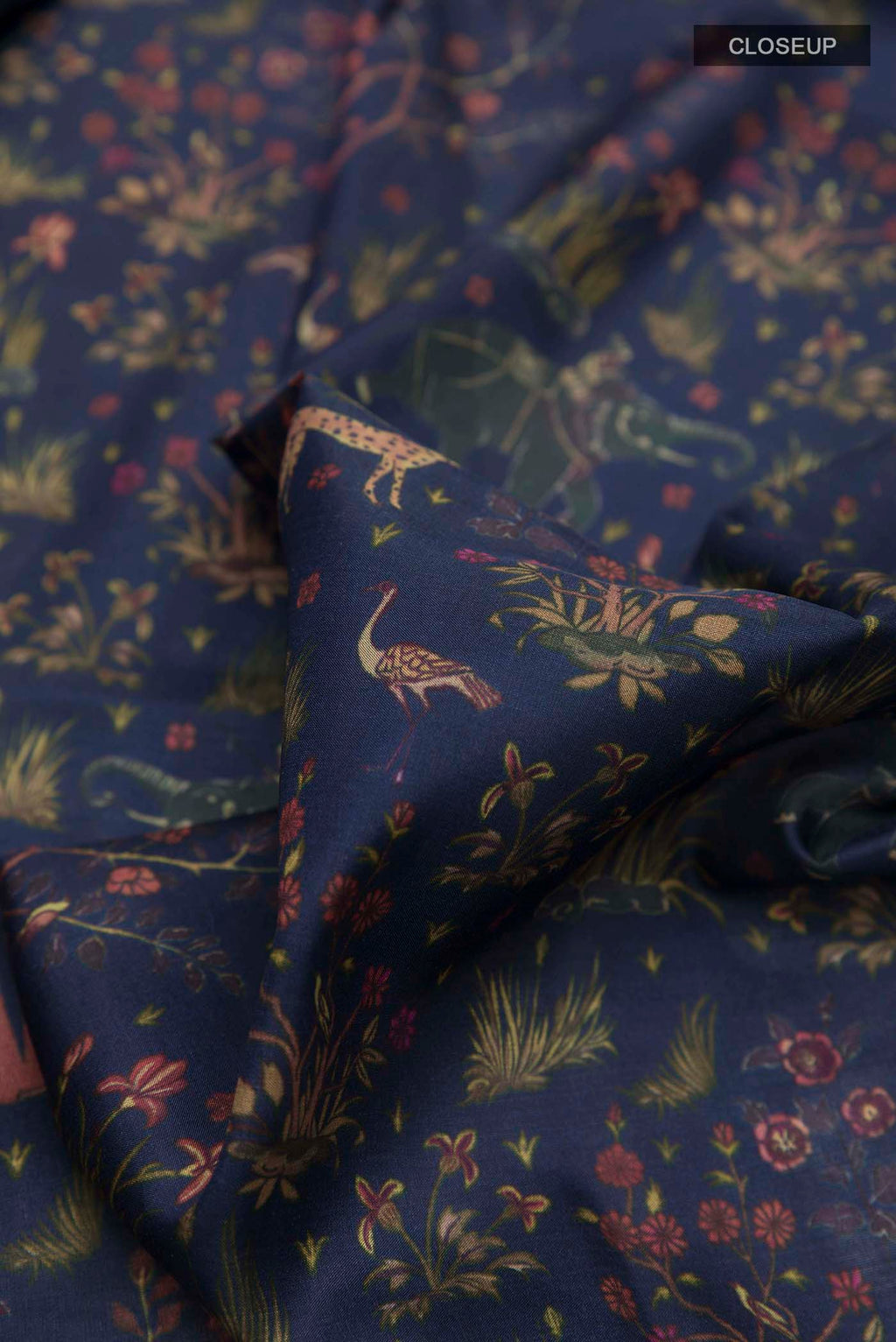 Close up of Blue Printed Silk Saree with Printed design on the body and Zari Border displaying folds