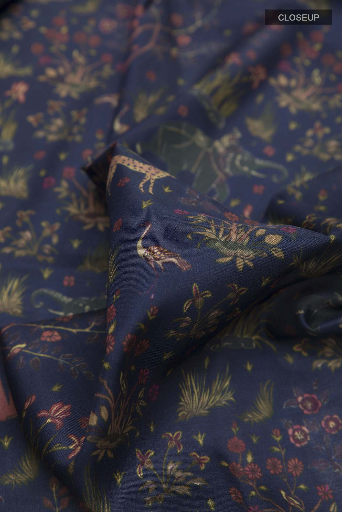 Close up of Blue Printed Silk Saree with Printed design on the body and Zari Border displaying folds