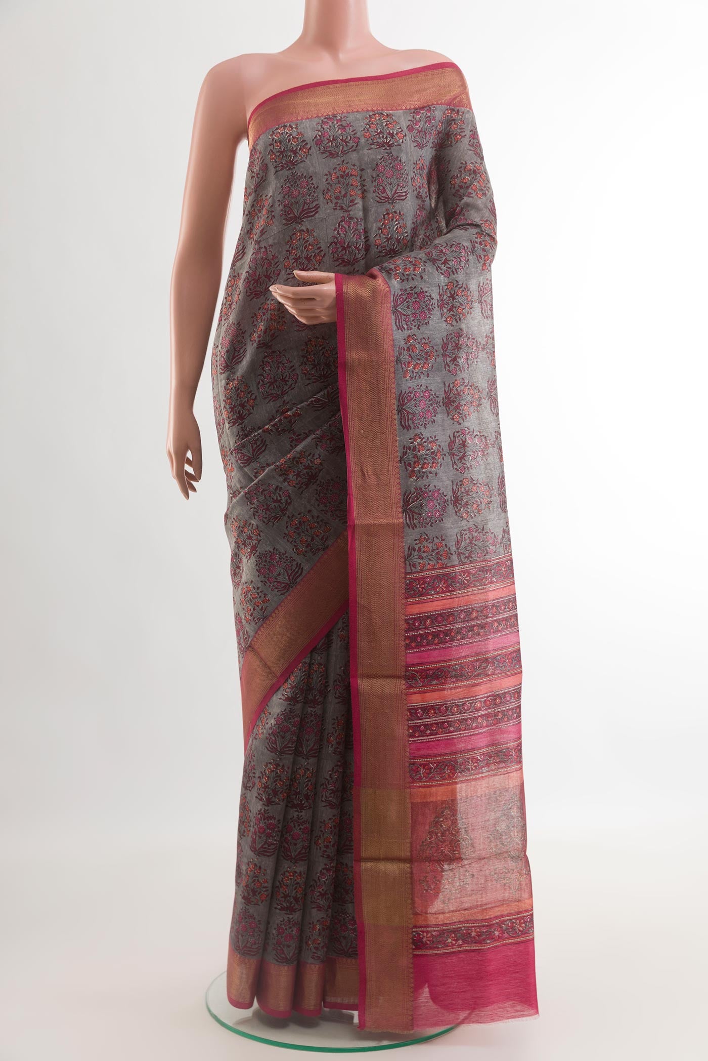 Grey Tussar Silk Saree with Printed design on the body and Zari Border.  displayed on a mannequin