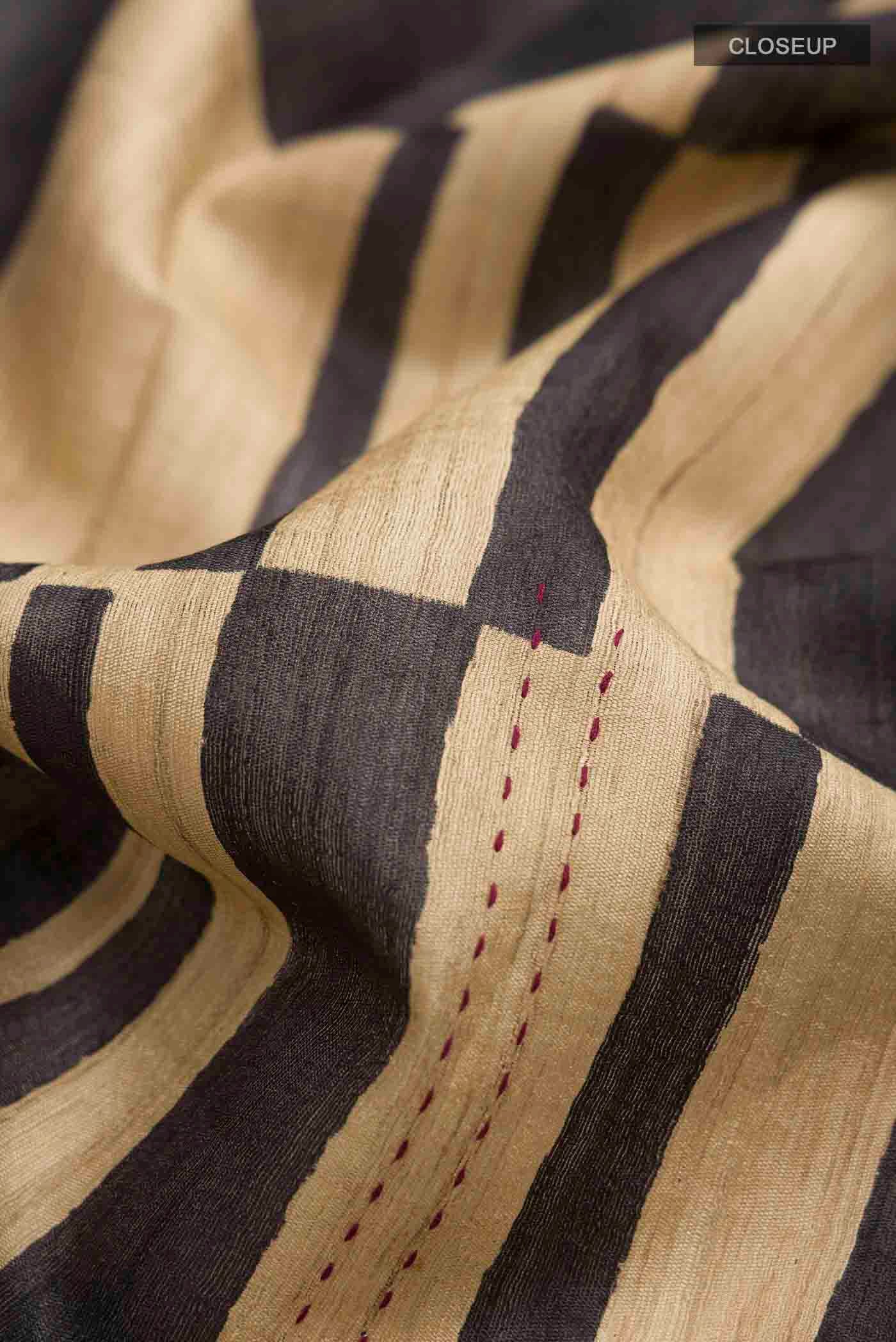 Close up of Multi Color Tussar Silk Saree with Stripes on the body and Zari Border displaying folds
