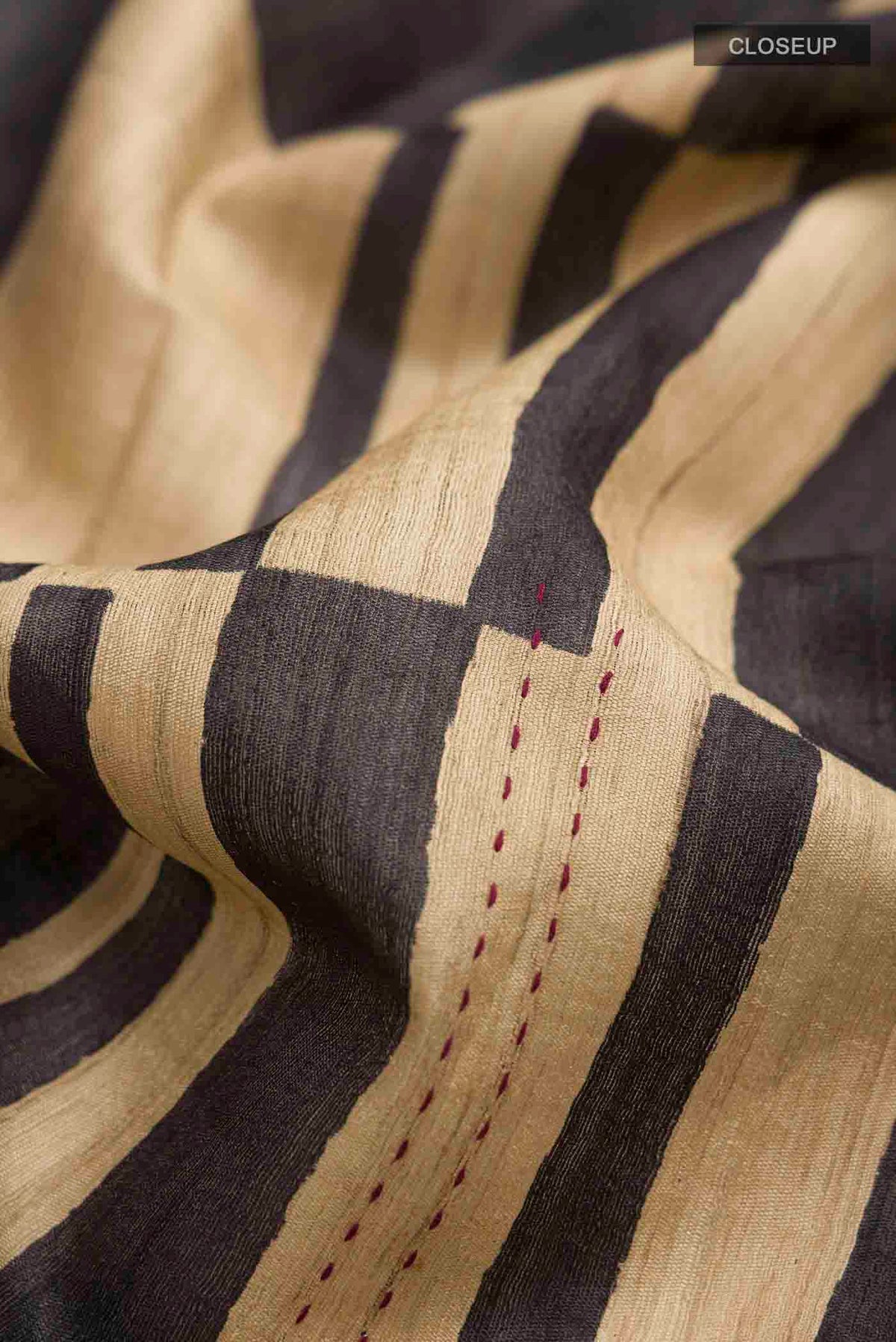 Close up of Multi Color Tussar Silk Saree with Stripes on the body and Zari Border displaying folds
