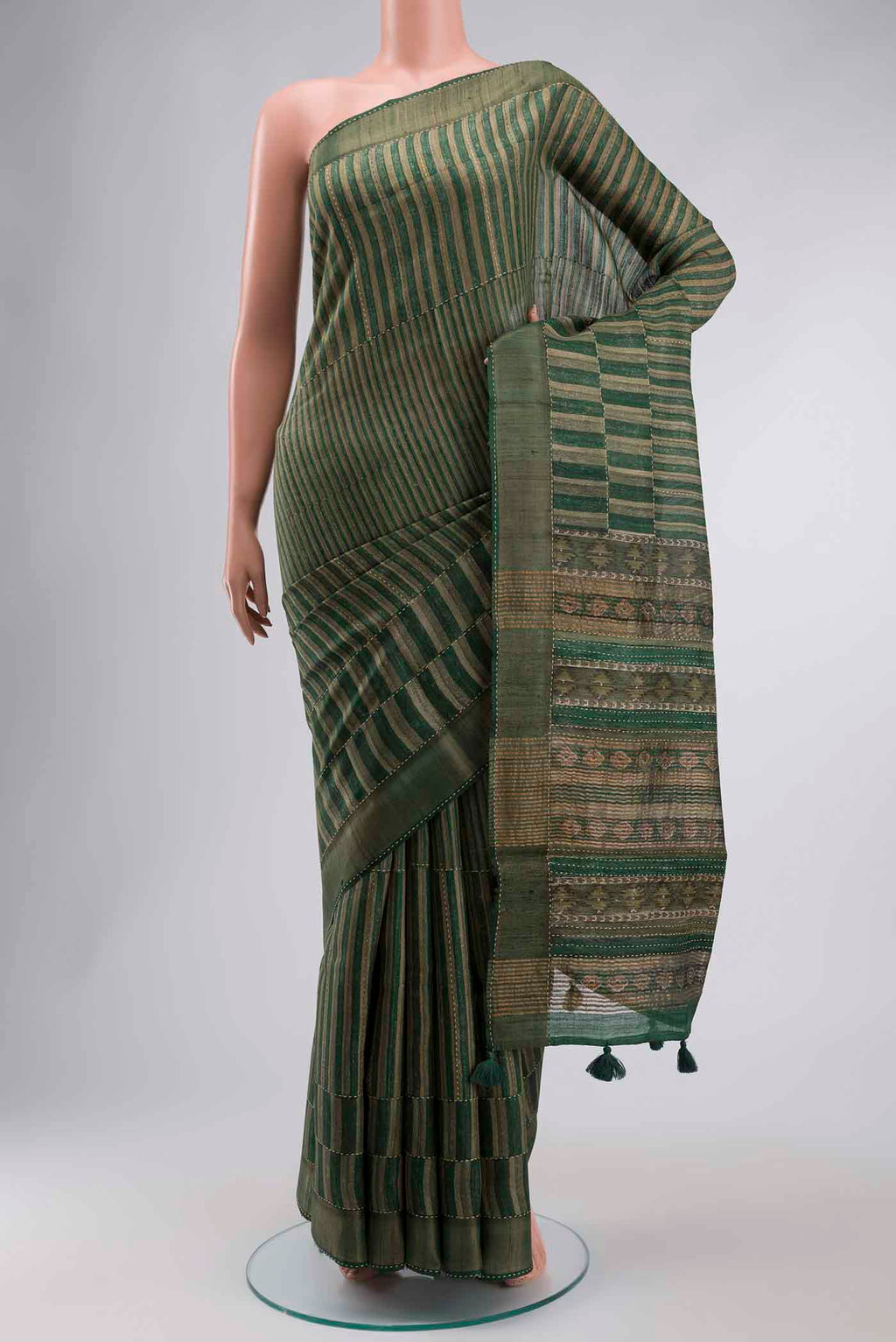 Green Tussar Silk Saree with Stripes on the body and Zari Border displayed on a mannequin