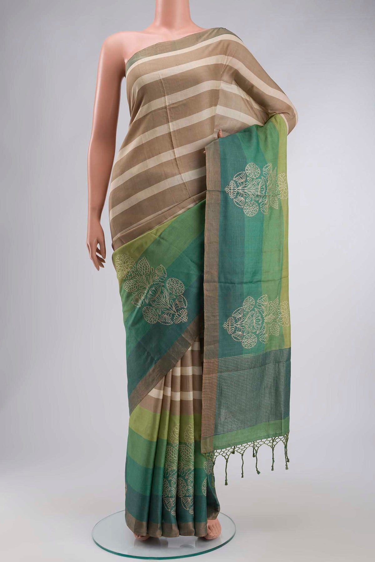 Beige Tussar Silk Saree with Stripes on the body and Zari Border displayed on a mannequin