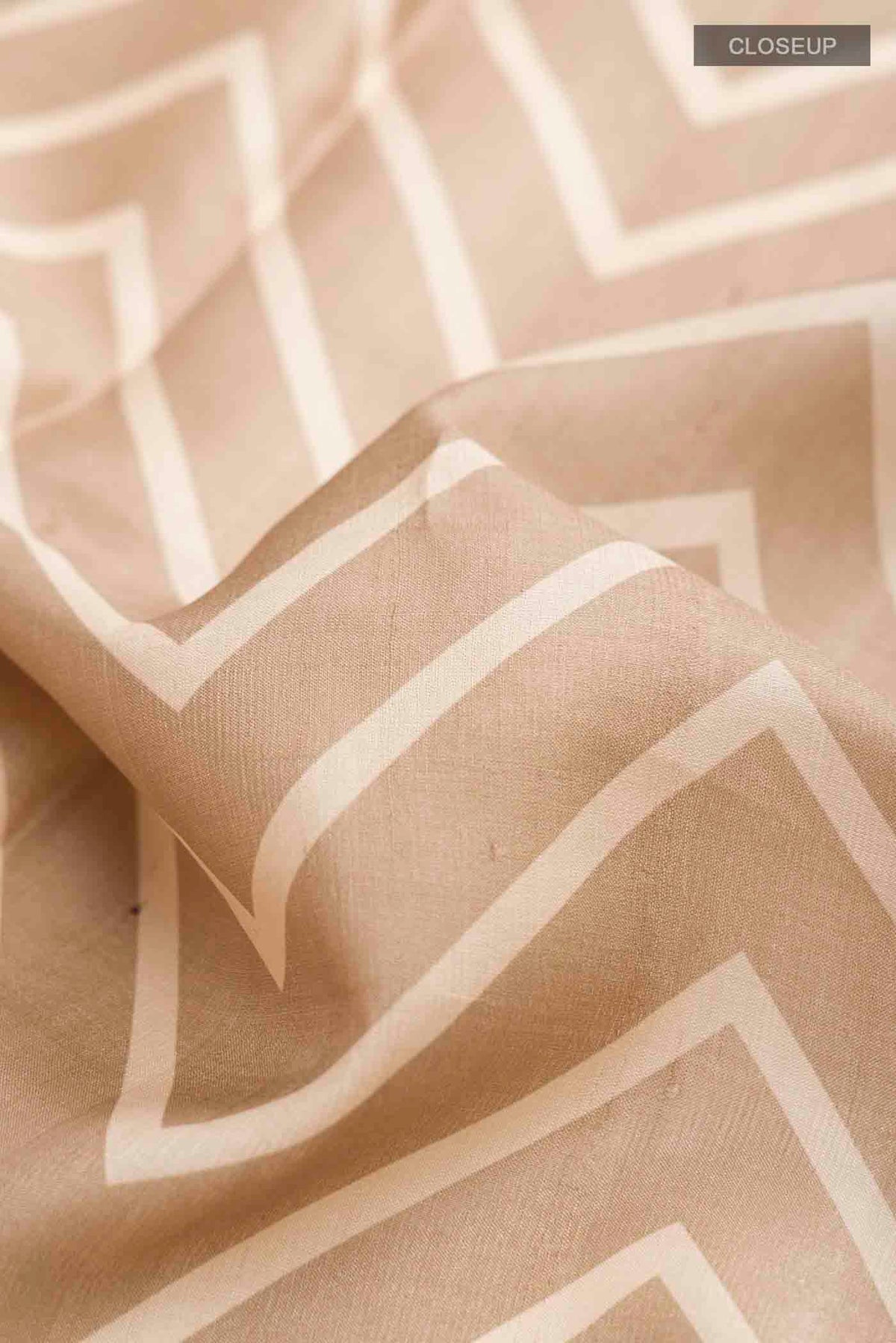 Close up of Beige Tussar Silk Saree with Stripes on the body and Zari Border displaying folds