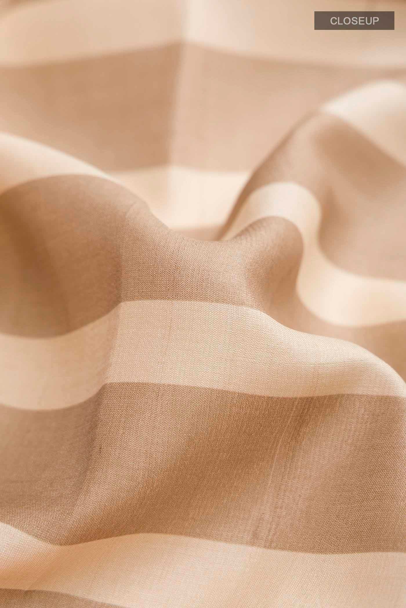 Close up of Multi Color Tussar Silk Saree with Stripes on the body and Zari Border displaying folds
