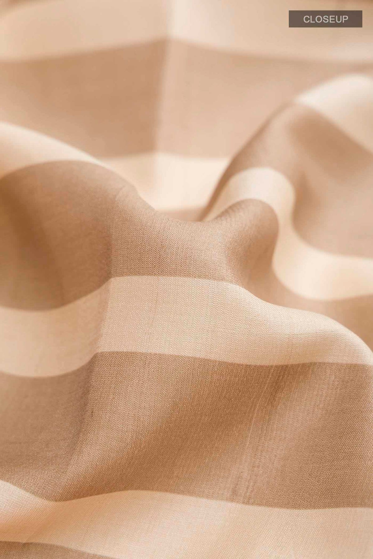 Close up of Multi Color Tussar Silk Saree with Stripes on the body and Zari Border displaying folds