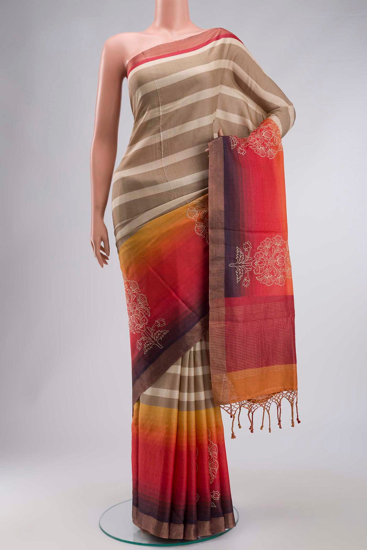 Multi Color Tussar Silk Saree with Stripes on the body and Zari Border displayed on a mannequin