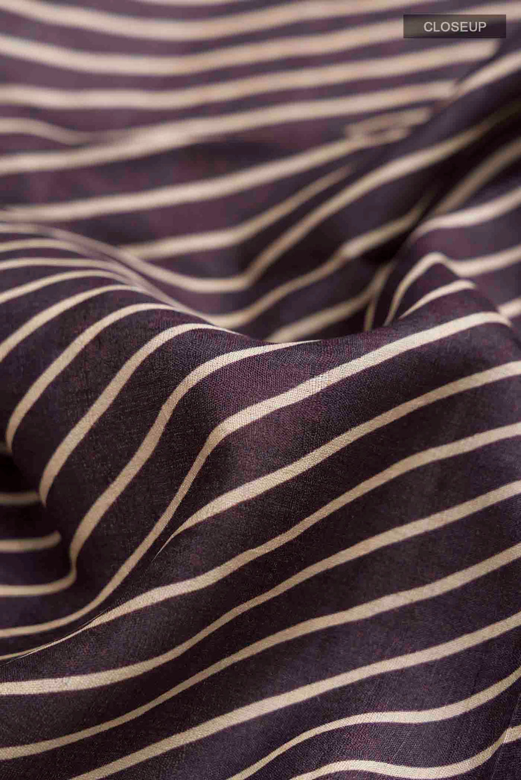 Close up of Brown Tussar Silk Saree with Stripes on the body and Embroidery Border displaying folds