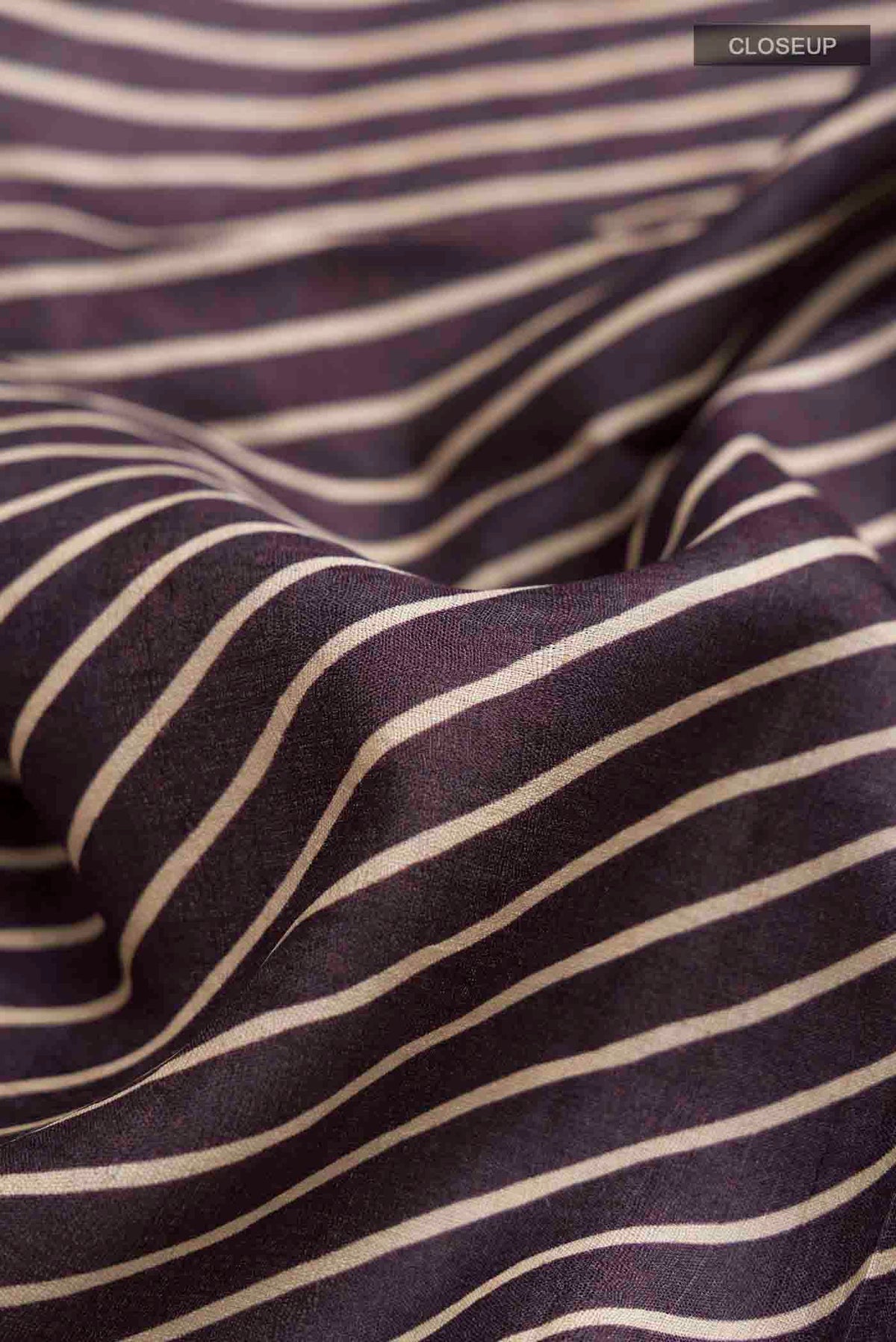 Close up of Brown Tussar Silk Saree with Stripes on the body and Embroidery Border displaying folds