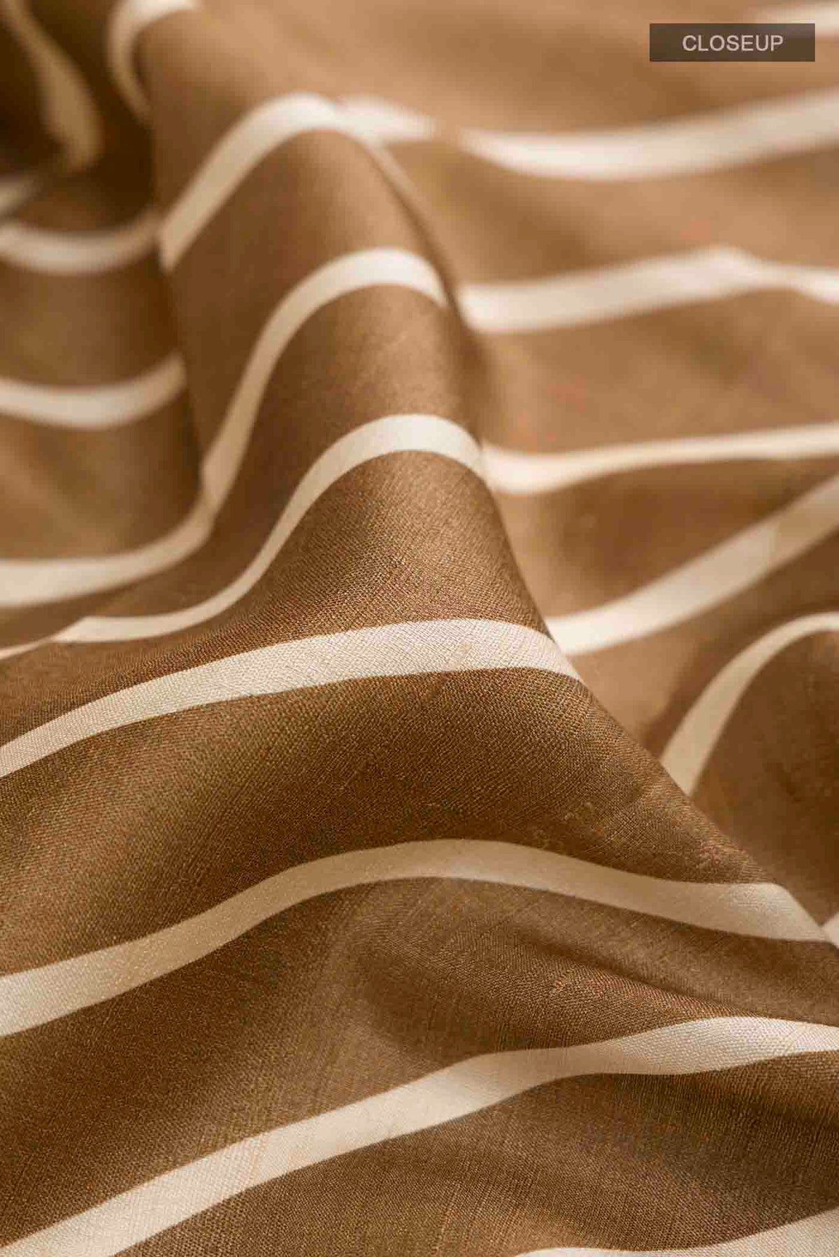 Close up of Brown Tussar Silk Saree with Stripes on the body and Embroidery Border displaying folds