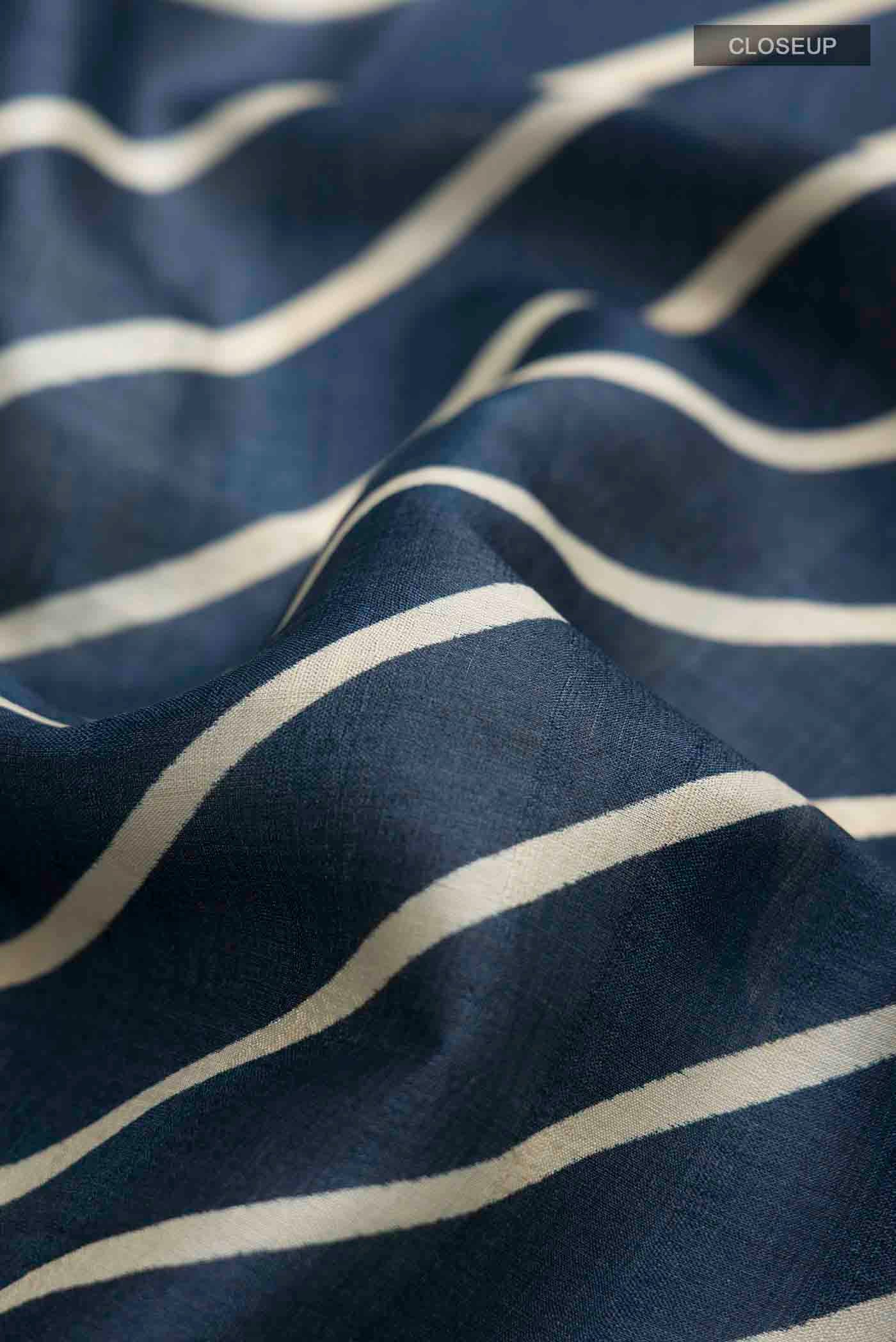 Close up of Blue Tussar Silk Saree with Stripes on the body and Embroidery Border displaying folds