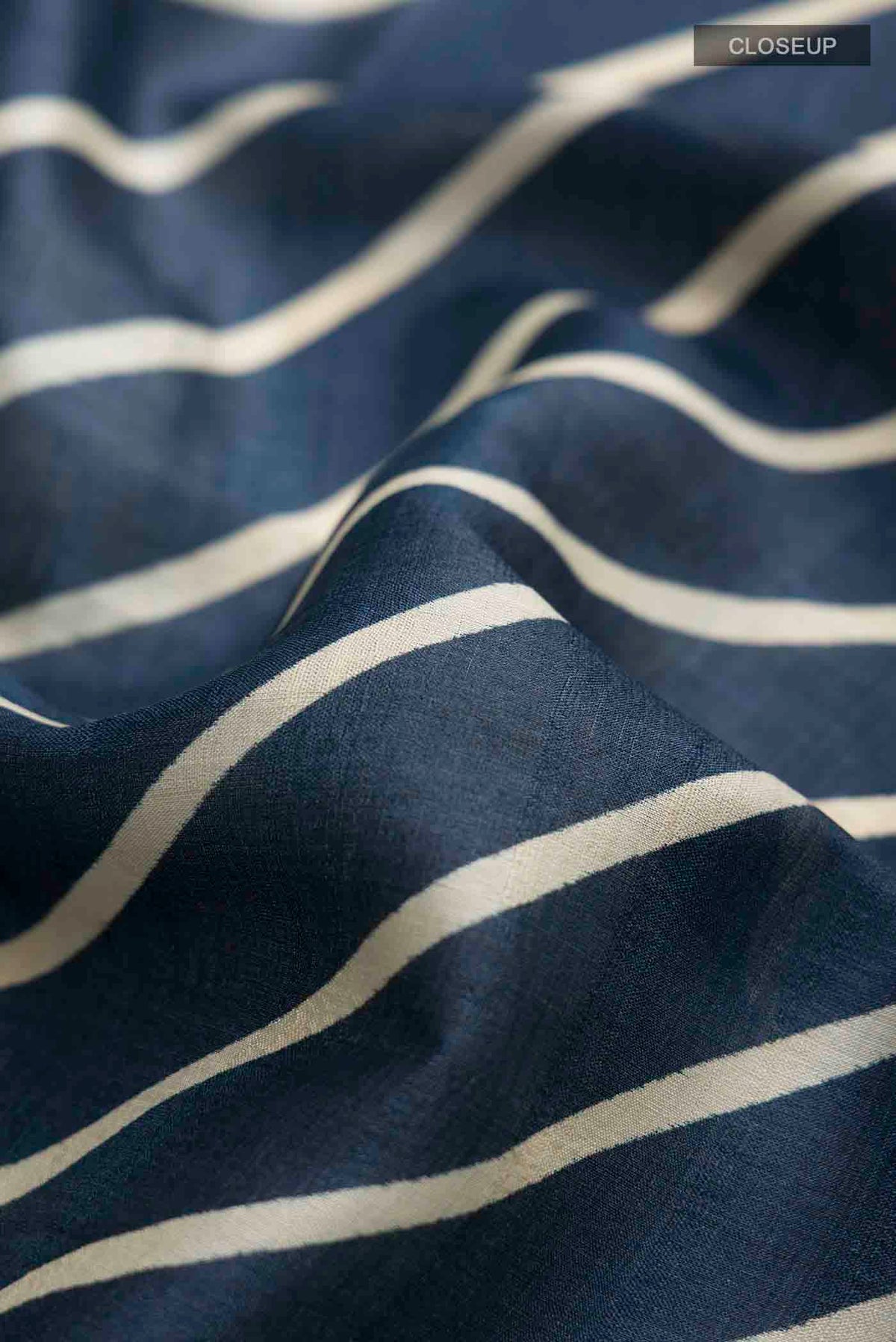 Close up of Blue Tussar Silk Saree with Stripes on the body and Embroidery Border displaying folds