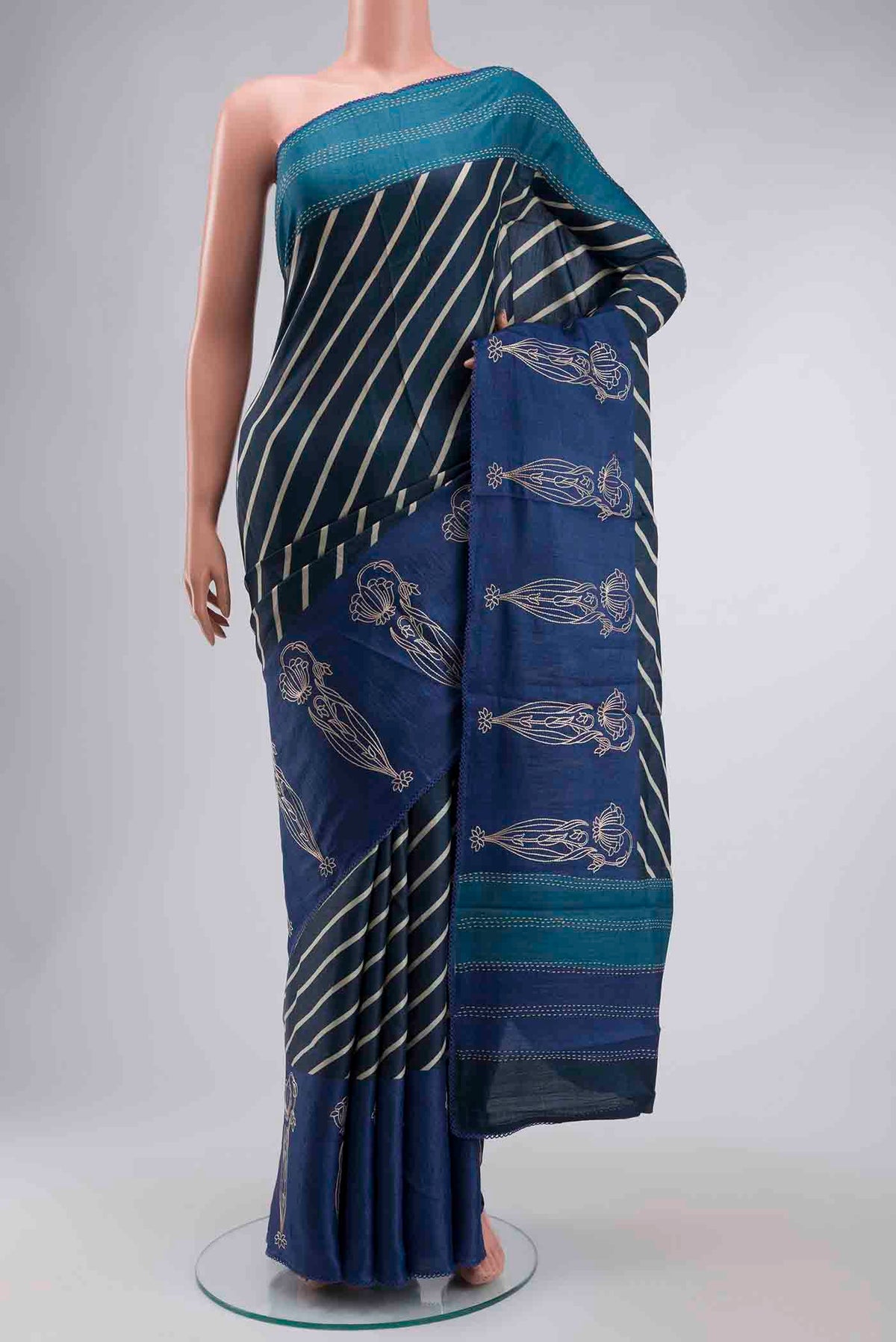 Blue Tussar Silk Saree with Stripes on the body and Embroidery Border displayed on a mannequin