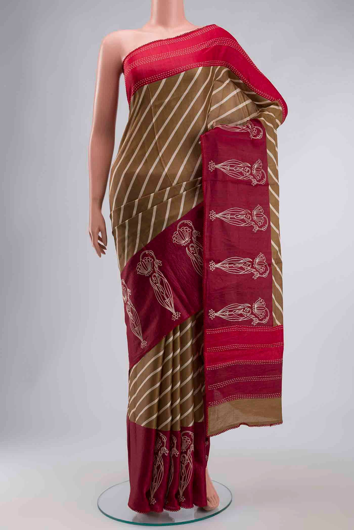 Green Tussar Silk Saree with Printed design on the body and Embroidery Border displayed on a mannequin