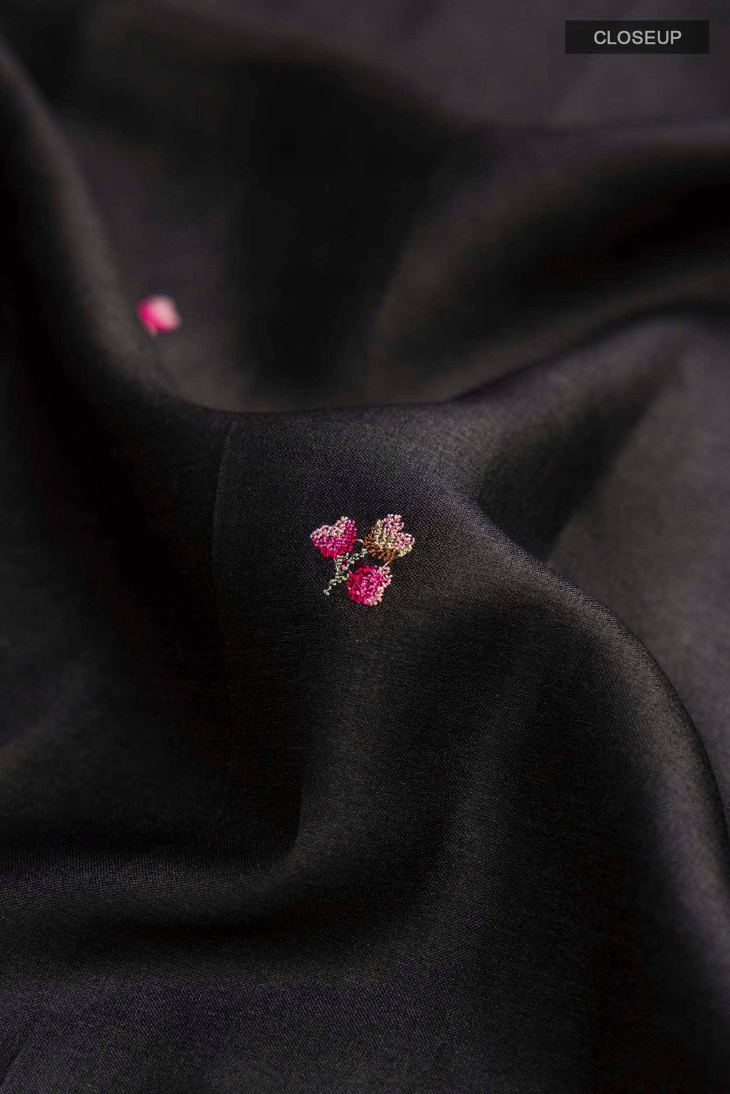 Close up of Black Tussar Silk Saree with Embroidery on the body and Embroidery Border displaying folds