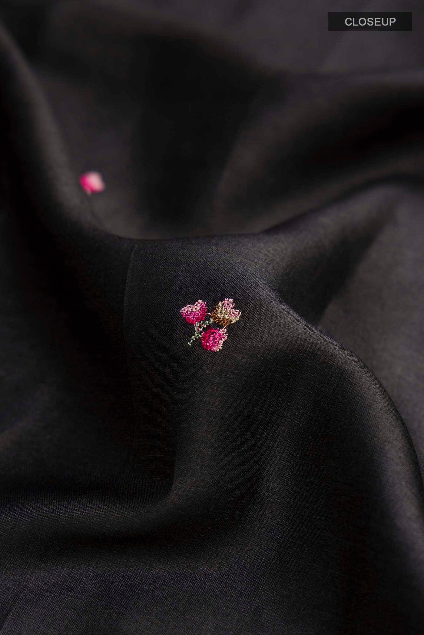 Close up of Black Tussar Silk Saree with Embroidery on the body and Embroidery Border displaying folds