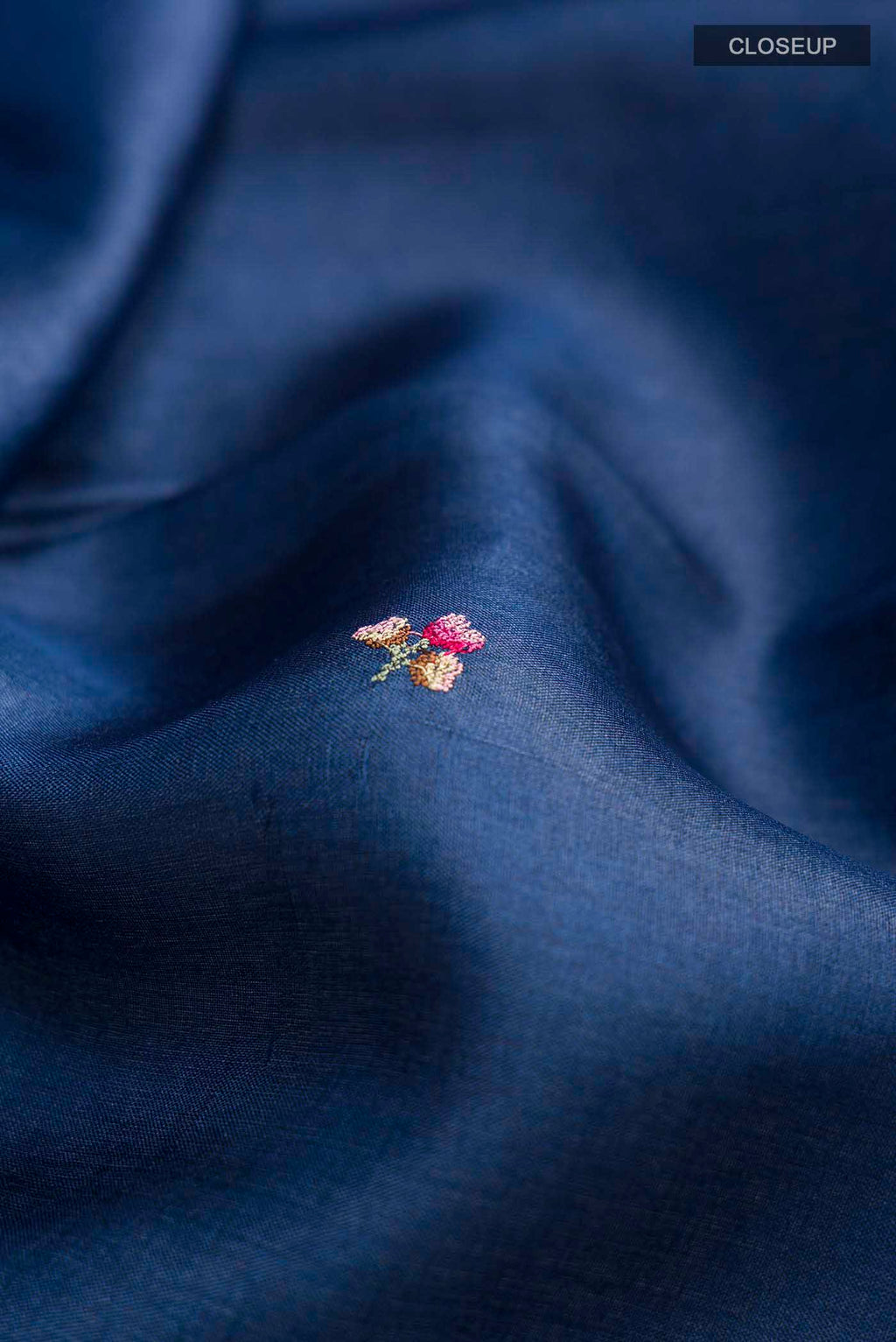 Close up of Blue Tussar Silk Saree with Embroidery on the body and Embroidery Border displaying folds