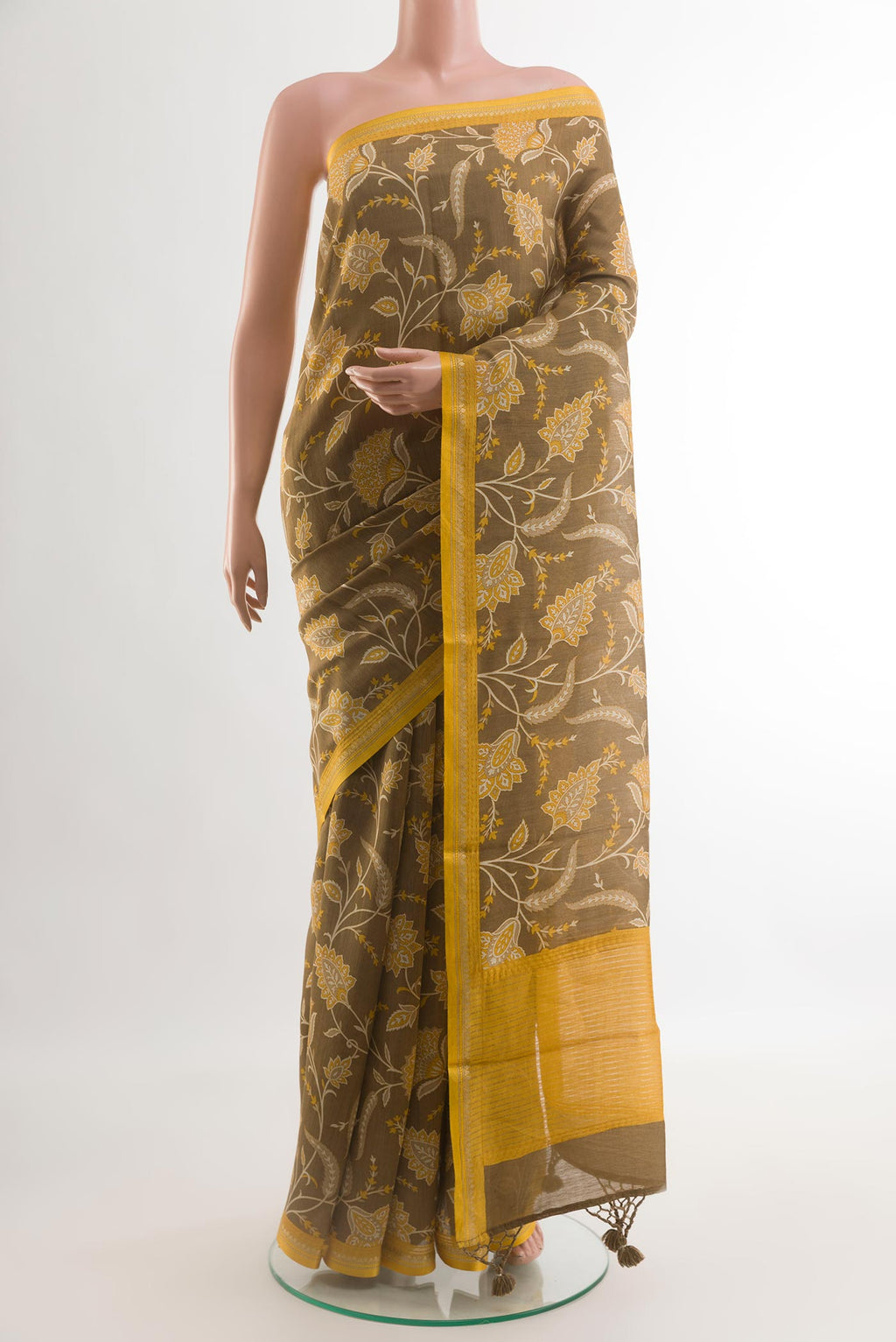 Brown Tussar Silk Saree with Printed design on the body and Zari Border.  displayed on a mannequin