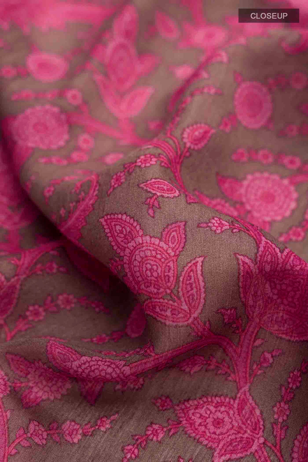 Close up of Coral Tussar Silk Saree with Printed design on the body and Thread Border displaying folds