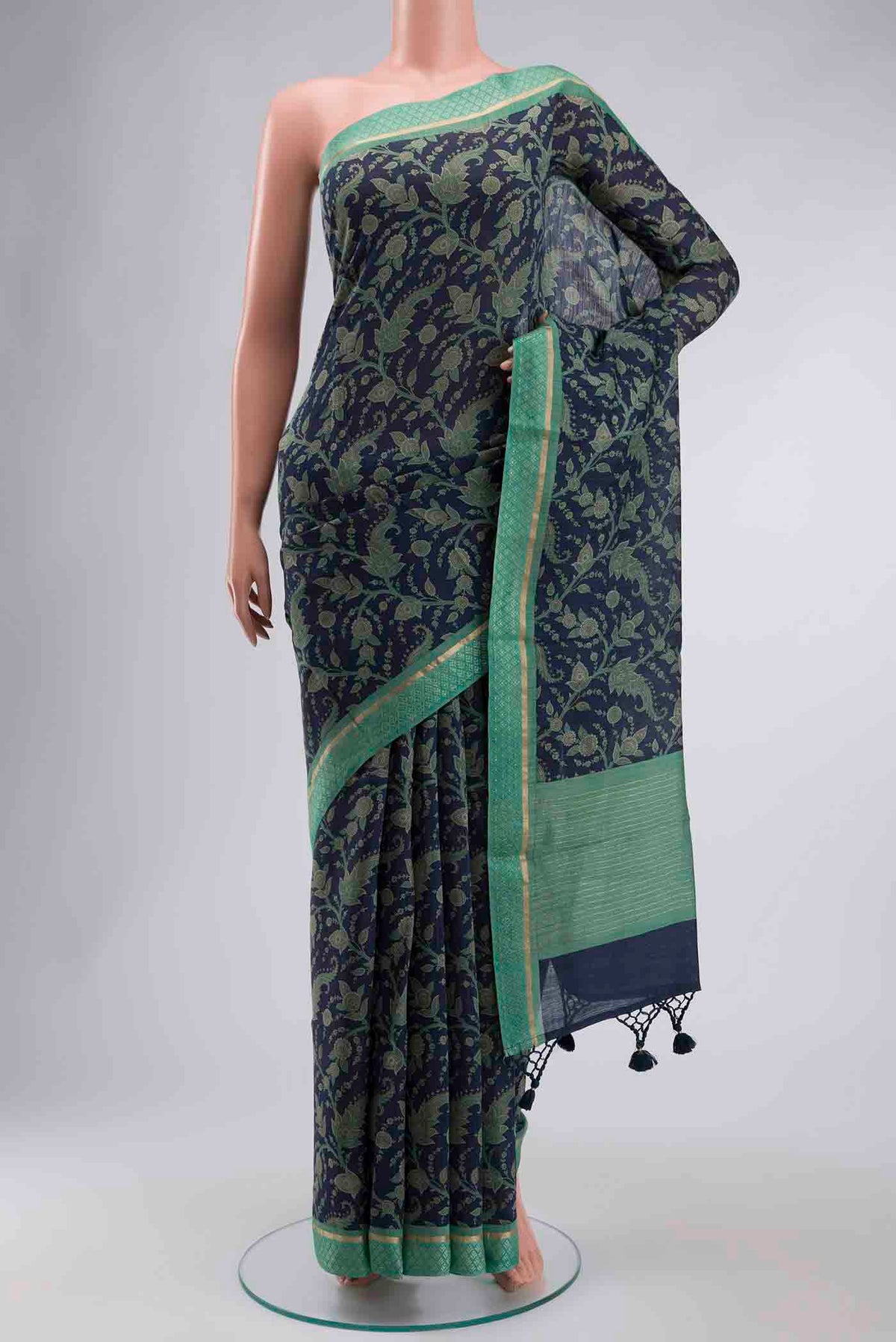 Blue Tussar Silk Saree with Printed design on the body and Zari Border displayed on a mannequin