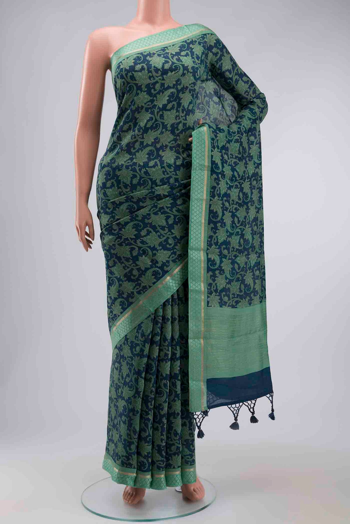 Blue Tussar Silk Saree with Printed design on the body and Zari And Thread Border displayed on a mannequin