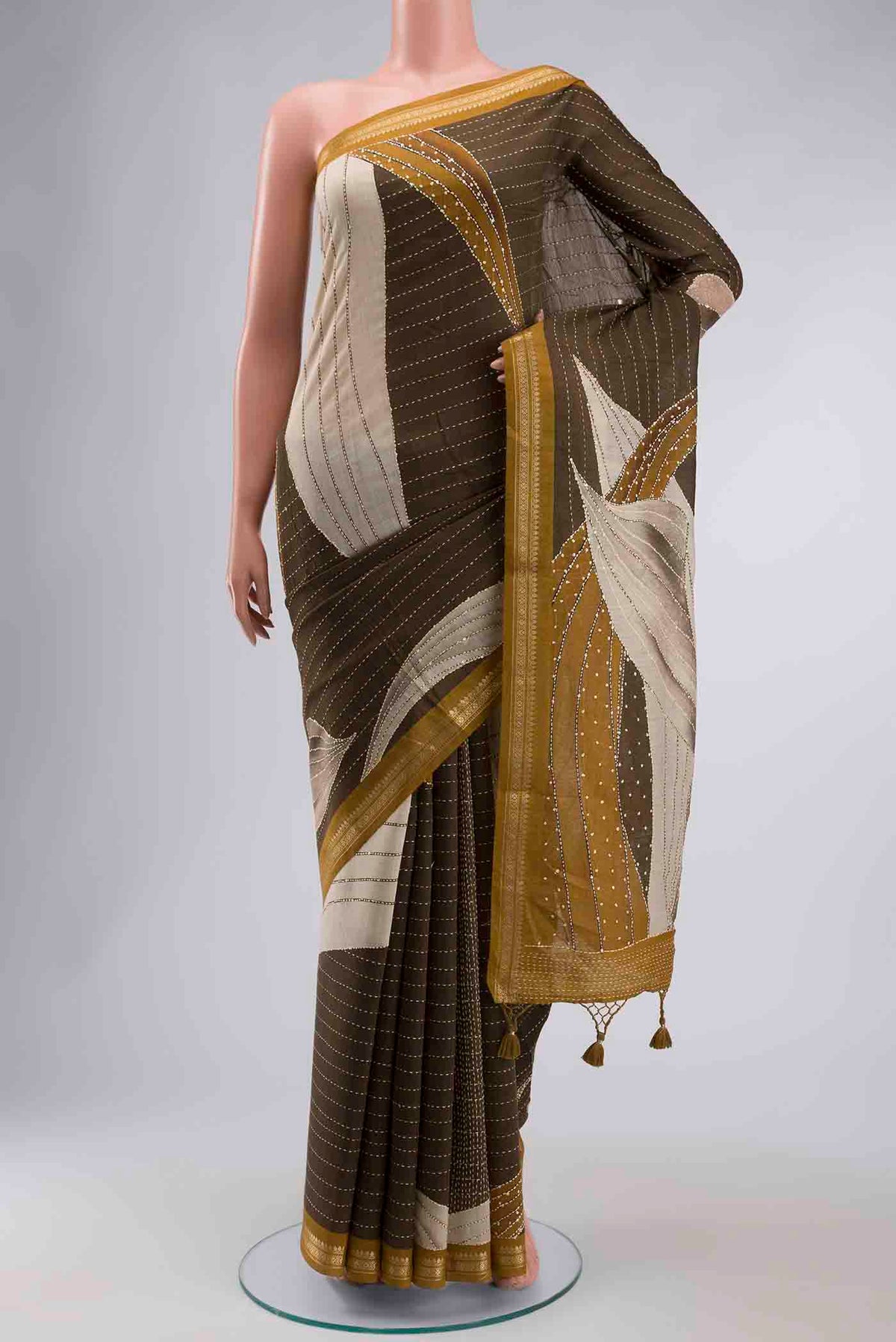 Green Tussar Silk Saree with Embroidery on the body and Zari Border displayed on a mannequin