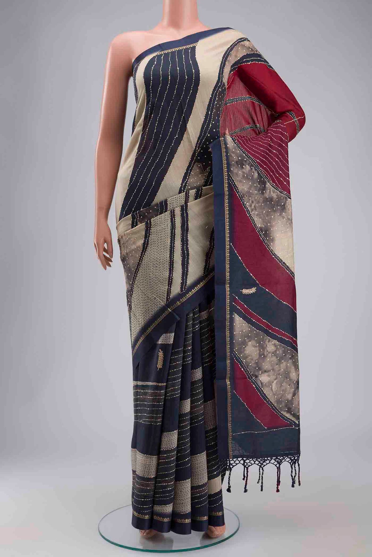 Maroon Tussar Silk Saree with Embroidery on the body and Zari Border displayed on a mannequin