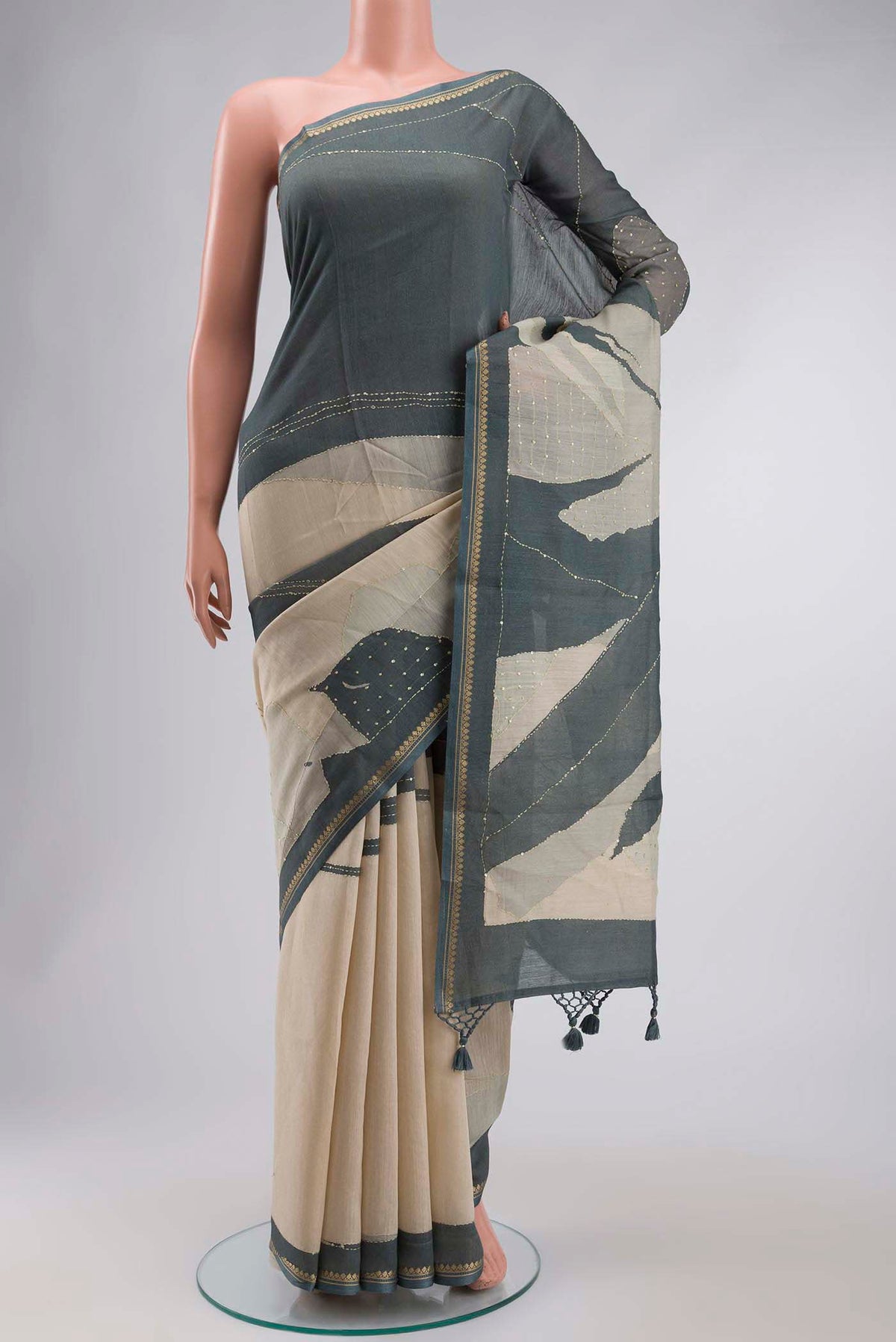 Cream Tussar Silk Saree with Embroidery on the body and Zari Border displayed on a mannequin