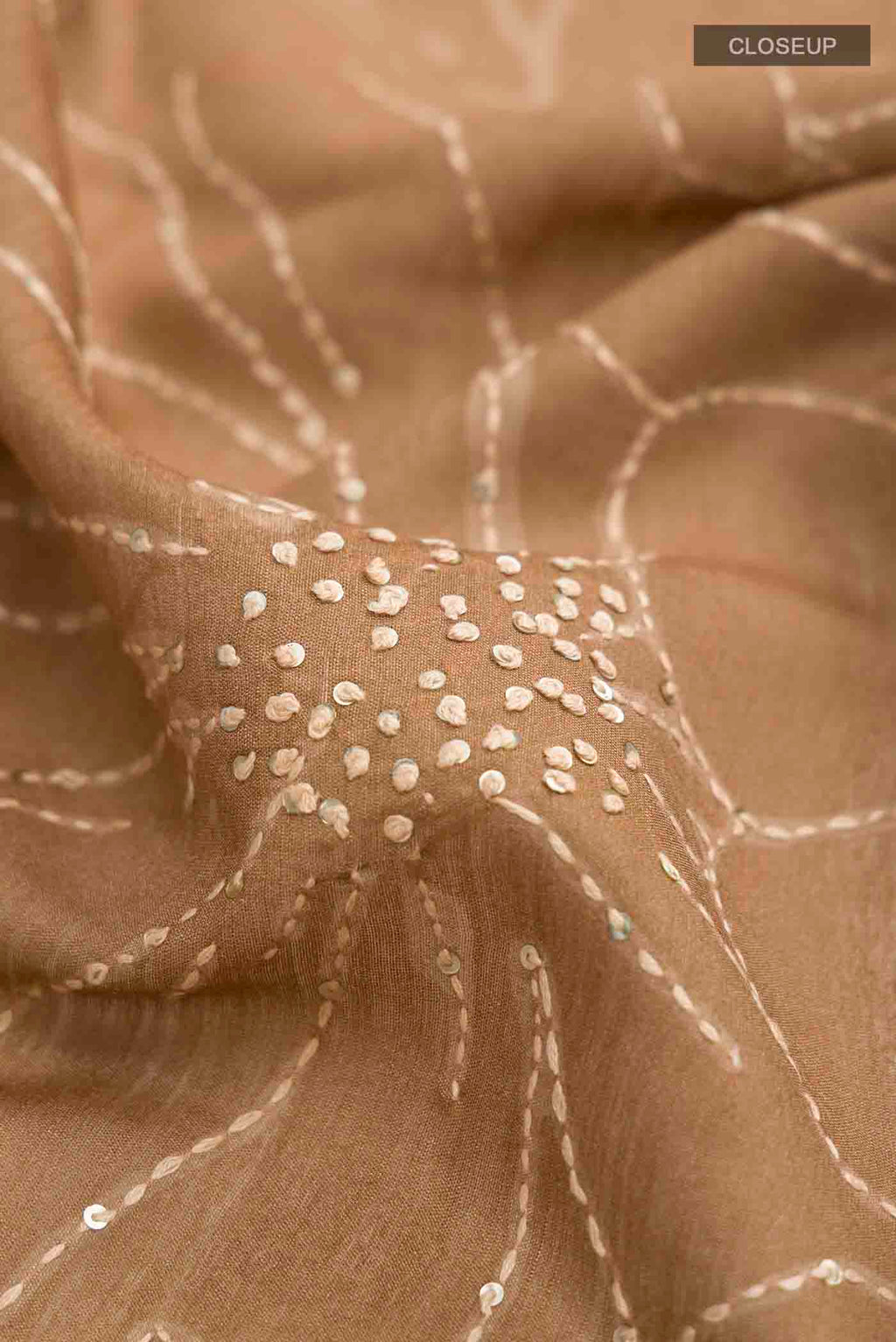 Close up of Green Tussar Silk Saree with Embroidery on the body and Zari Border displaying folds